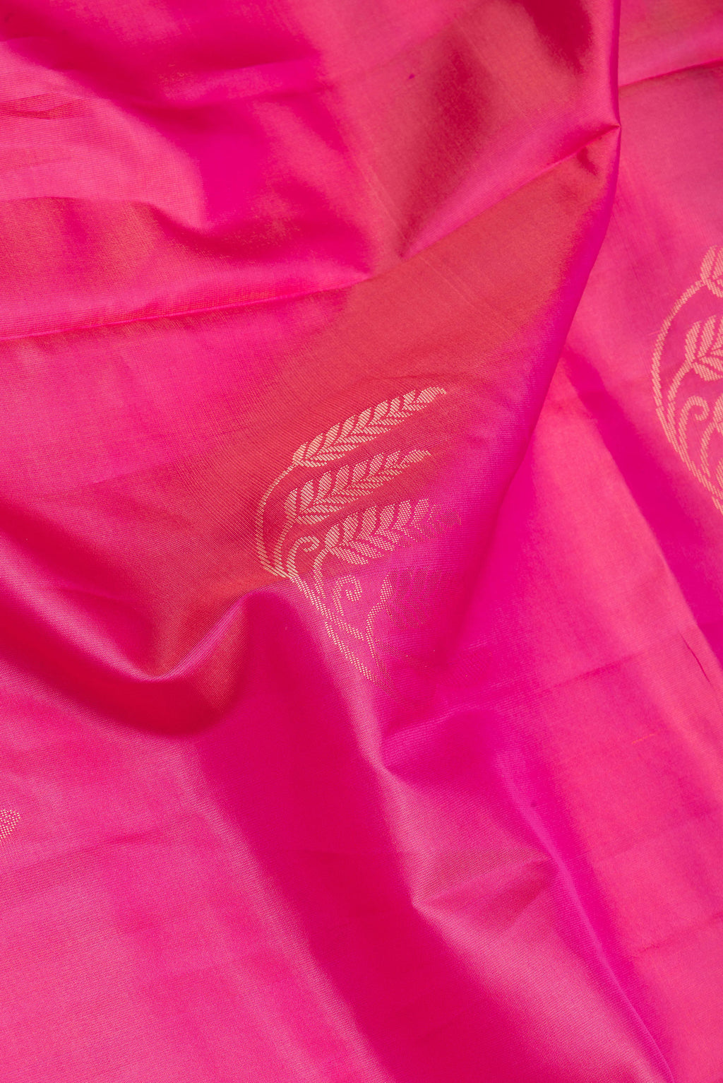 Close up of Pink Soft Silk Saree with Zari Butta on the body and Zari Border.  displaying folds