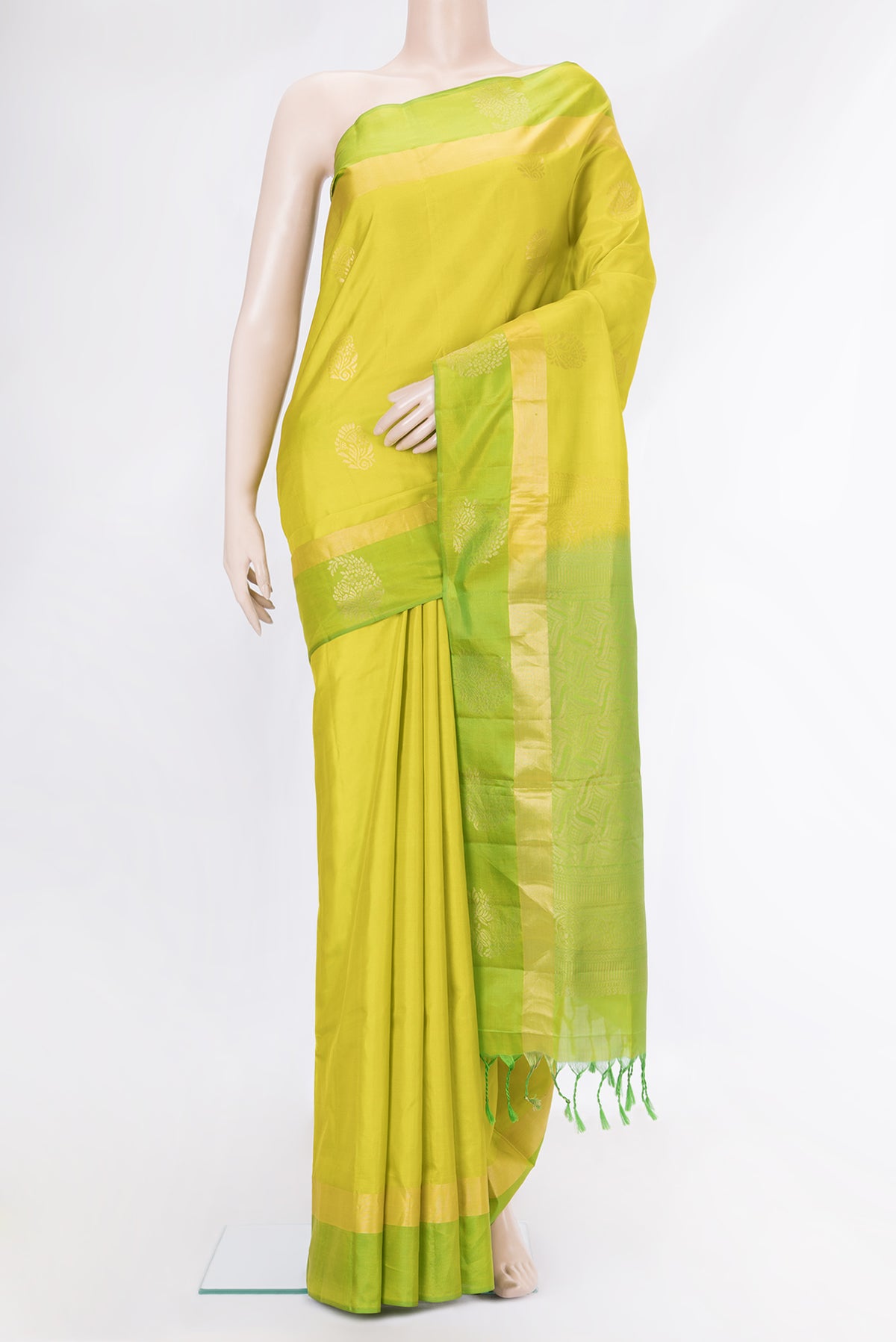 Parrot Green Dual Tone Soft Silk Saree with Zari Butta on the body and Fancy Border.  displayed on a mannequin