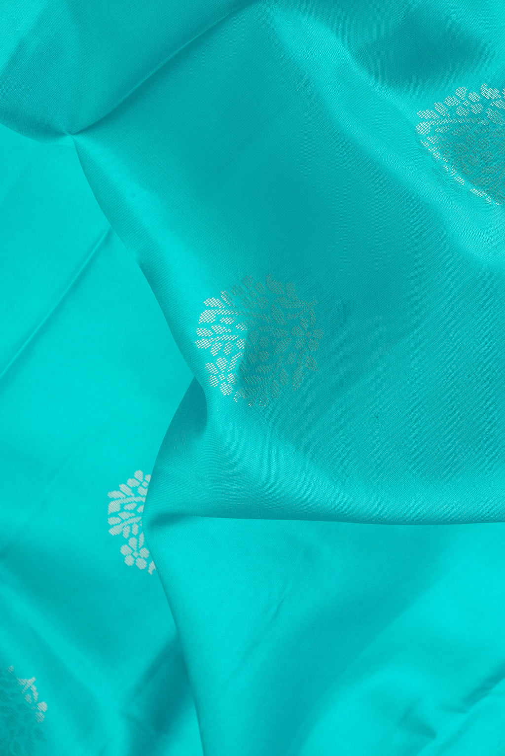 Close up of Sky Blue Dual Tone Soft Silk Saree with Zari Butta on the body and Fancy Border.  displaying folds