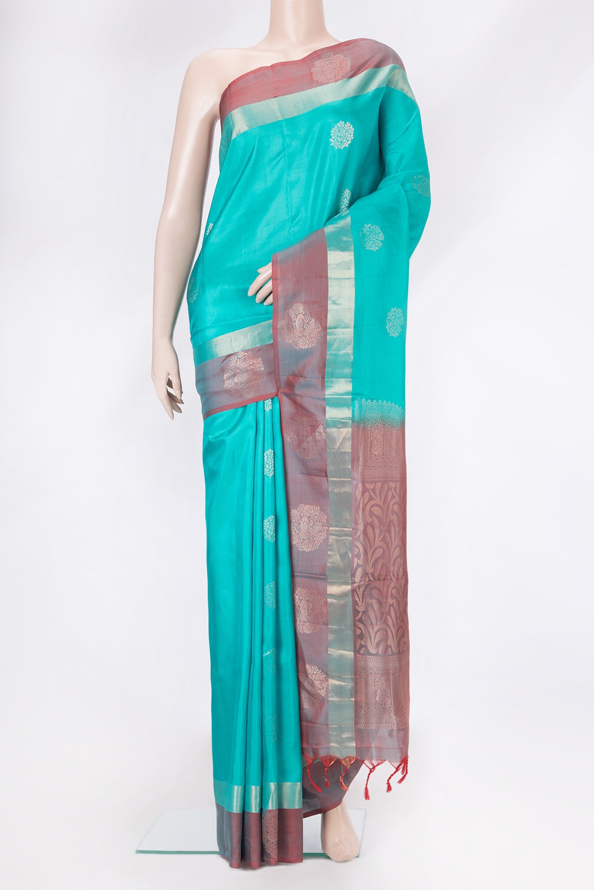 Sky Blue Dual Tone Soft Silk Saree with Zari Butta on the body and Fancy Border.  displayed on a mannequin
