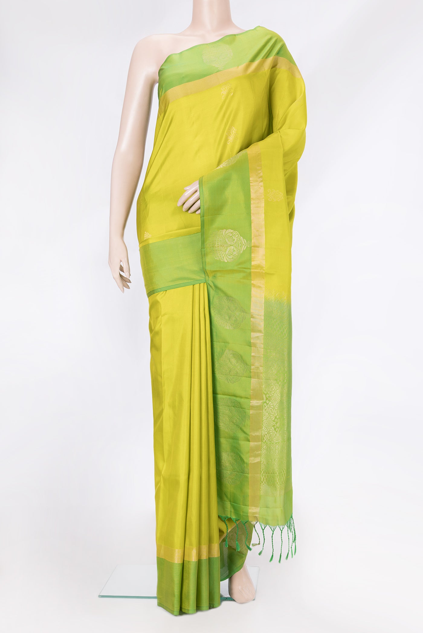 Parrot Green Dual Tone Soft Silk Saree with Zari Butta on the body and Fancy Border.  displayed on a mannequin