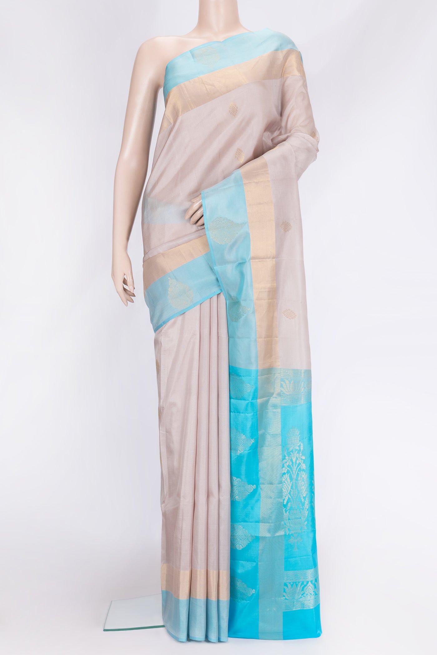 Rose Gold Dual Tone Soft Silk Saree with Zari Butta on the body and Fancy Border.  displayed on a mannequin