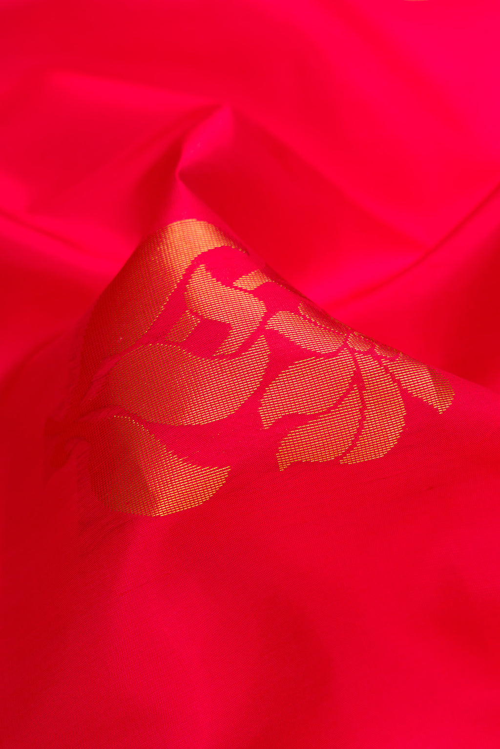 Close up of Red Dual Tone Soft Silk Saree with Zari Butta on the body and Zari Border.  displaying folds