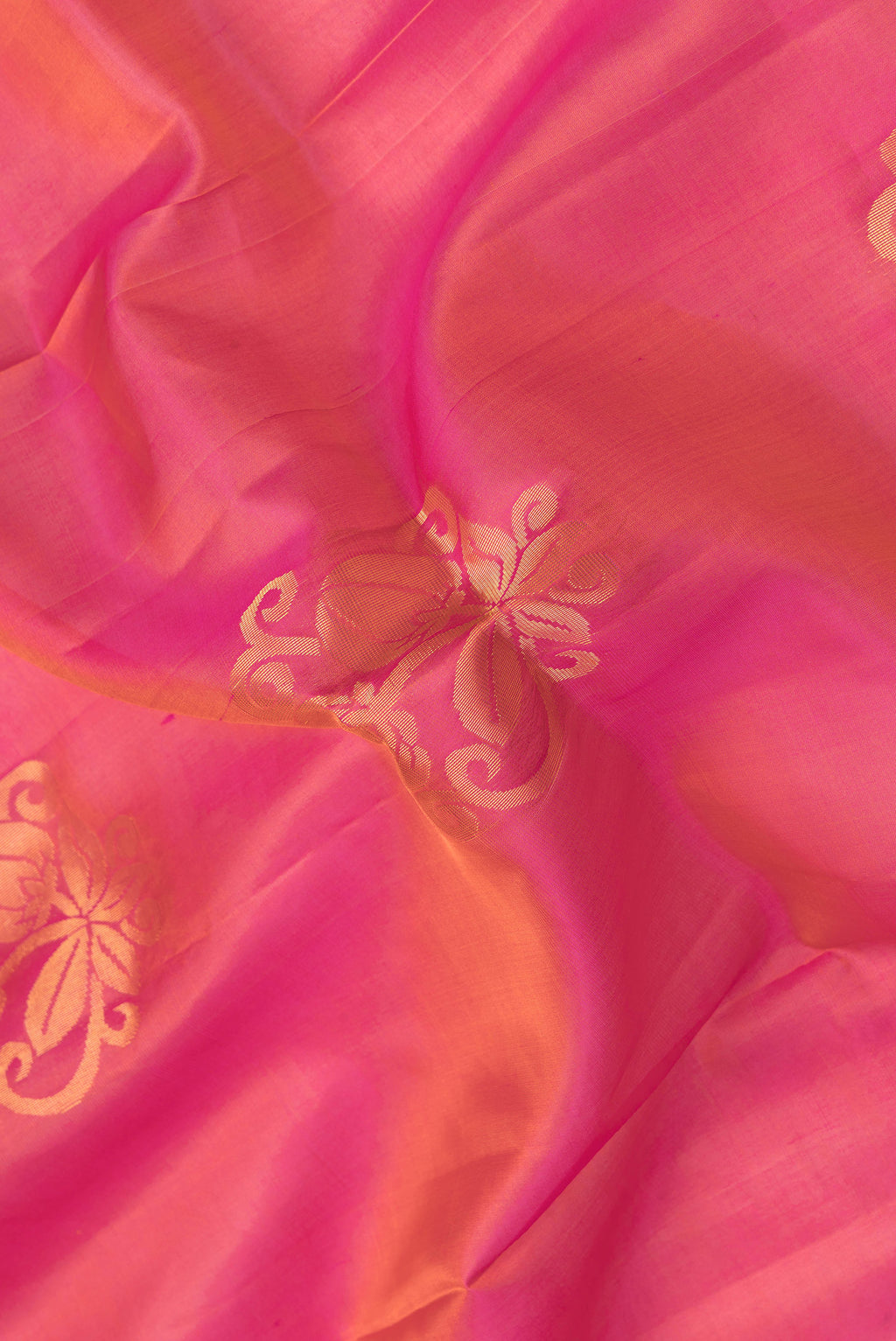 Close up of Pink Dual Tone Soft Silk Saree with Zari Butta on the body and Zari Border.  displaying folds