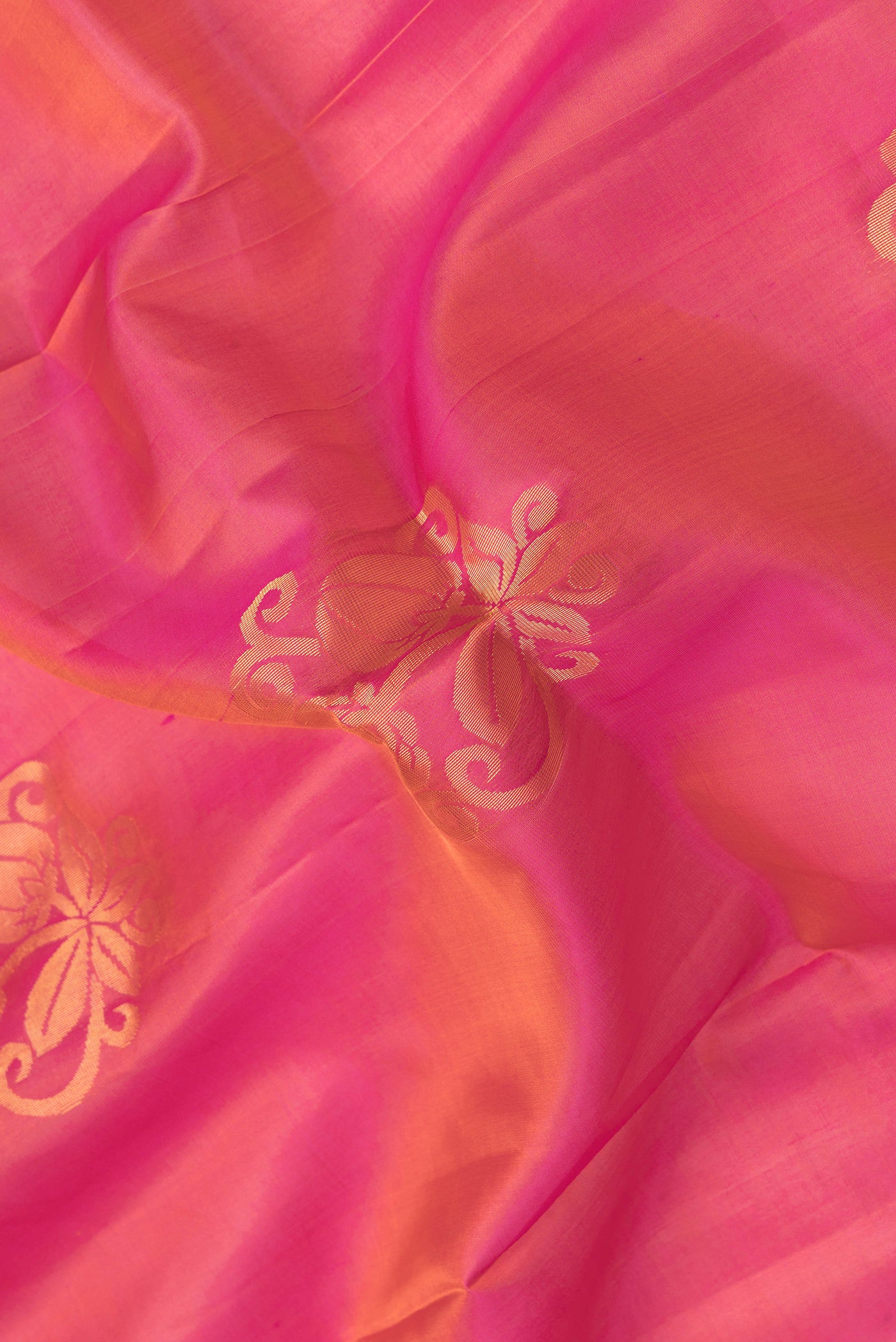 Close up of Pink Dual Tone Soft Silk Saree with Zari Butta on the body and Zari Border.  displaying folds