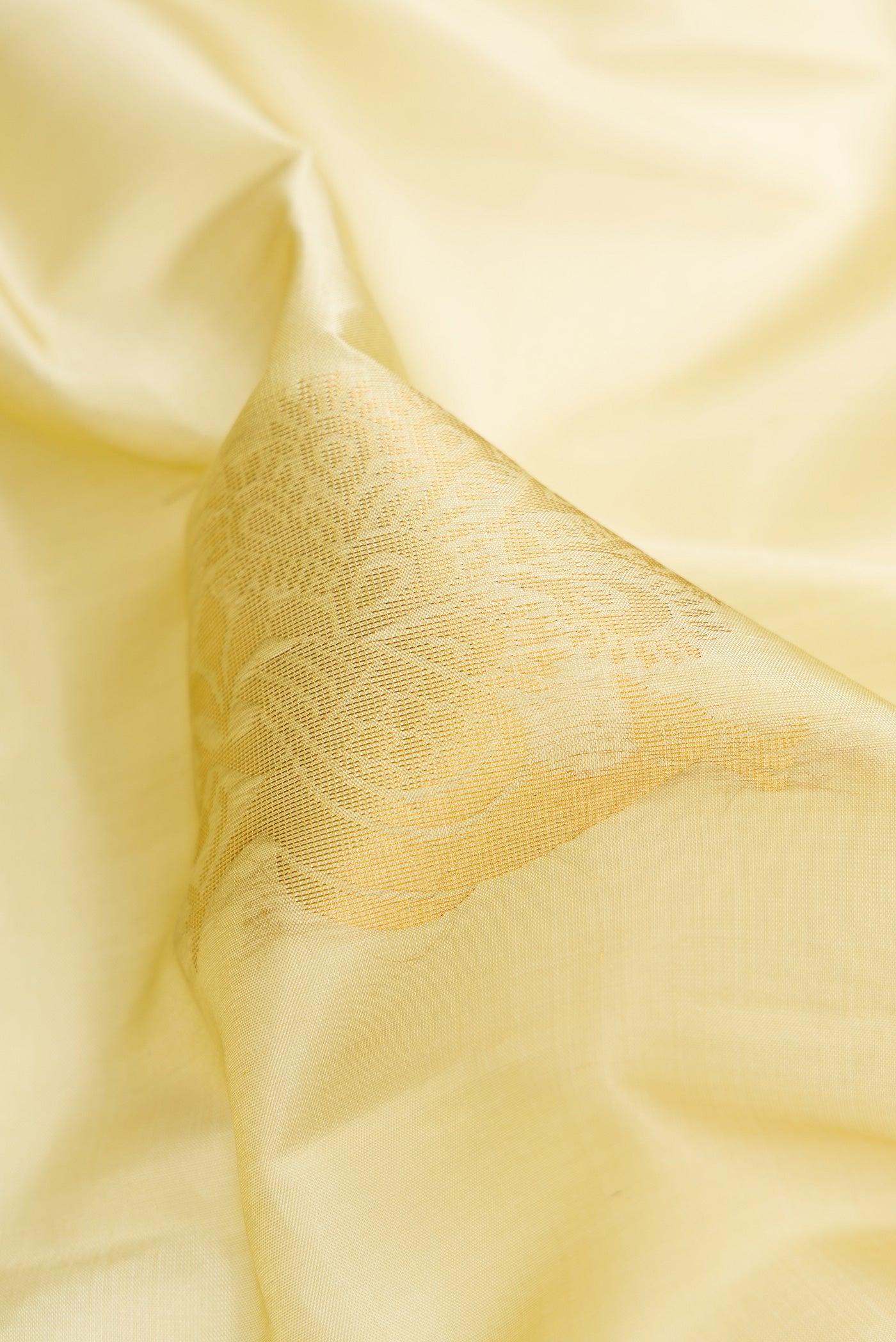 Close up of Pista Green Dual Tone Soft Silk Saree with Zari Butta on the body and Zari Border.  displaying folds