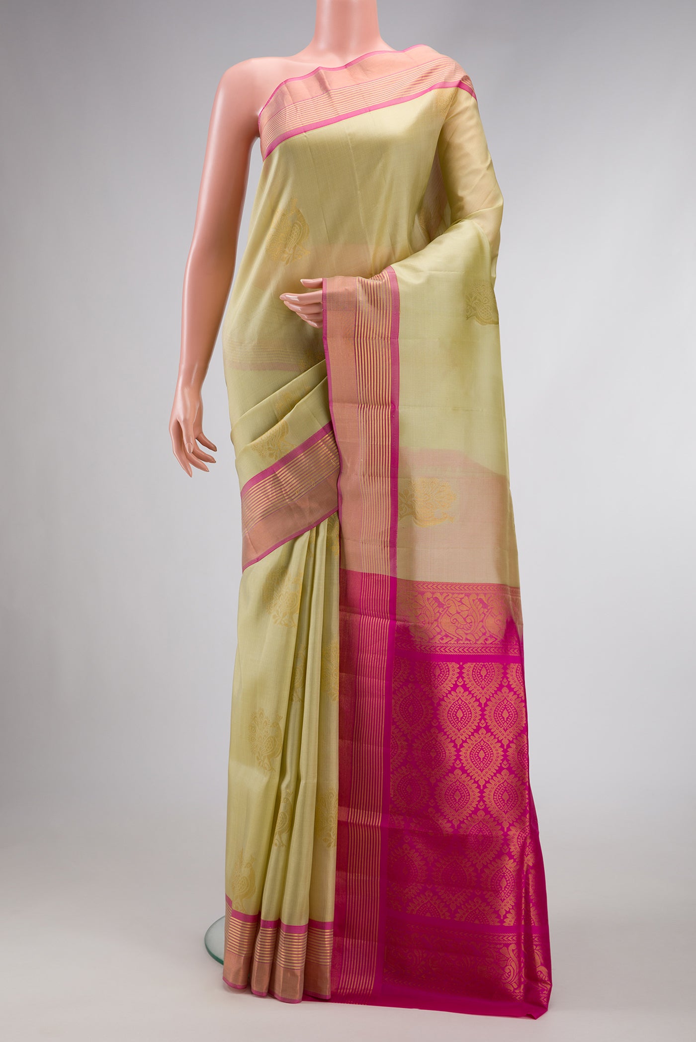 Pista Green Dual Tone Soft Silk Saree with Zari Butta on the body and Zari Border.  displayed on a mannequin