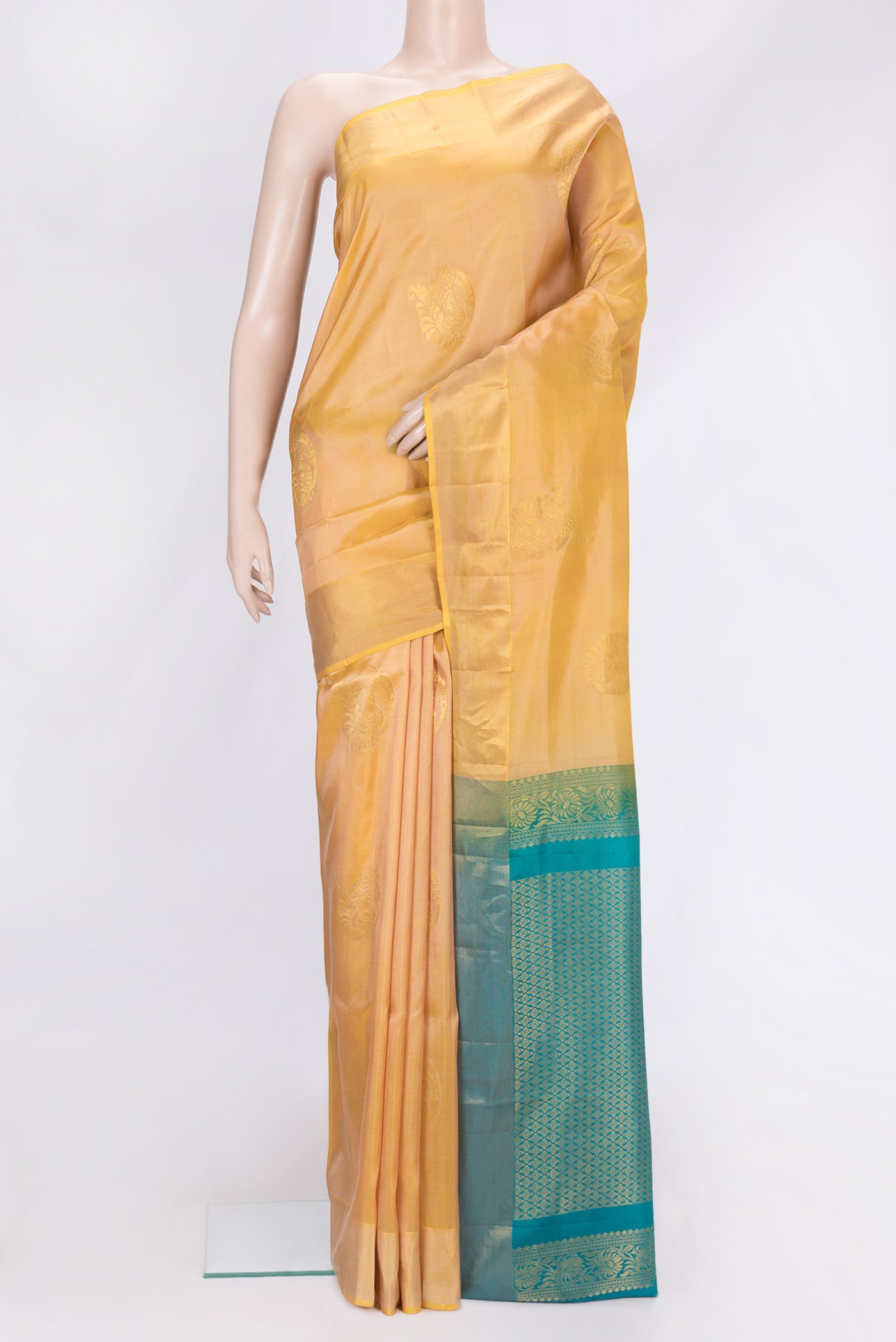 Gold Dual Tone Soft Silk Saree with Zari Butta on the body and Zari Border.  displayed on a mannequin
