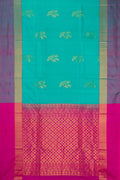 Sea Green Soft Silk Saree with Zari Butta on the body and Fancy Border.  displayed on a mannequin