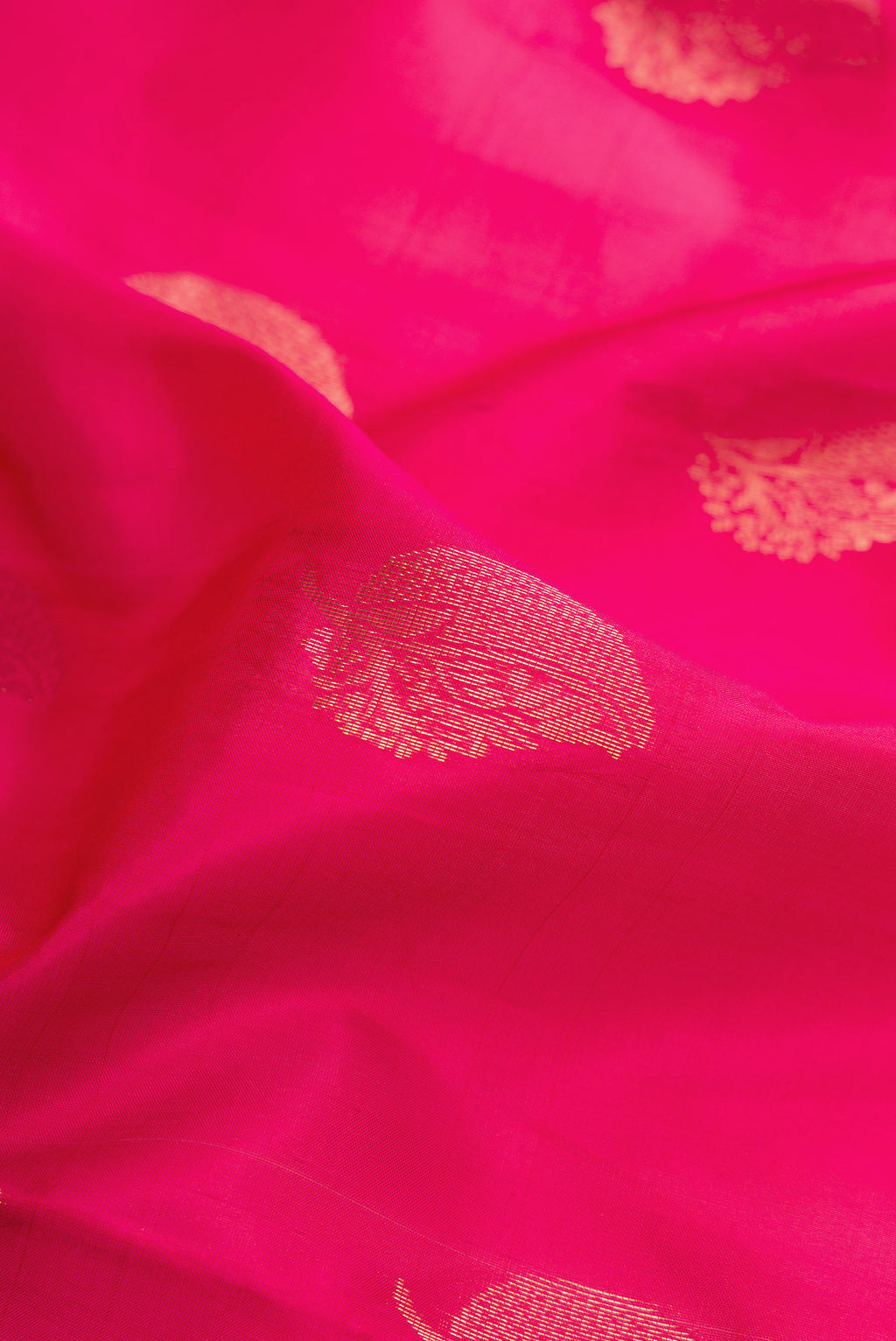 Close up of Dark Pink Soft Silk Saree with Zari Butta on the body and Fancy Border.  displaying folds