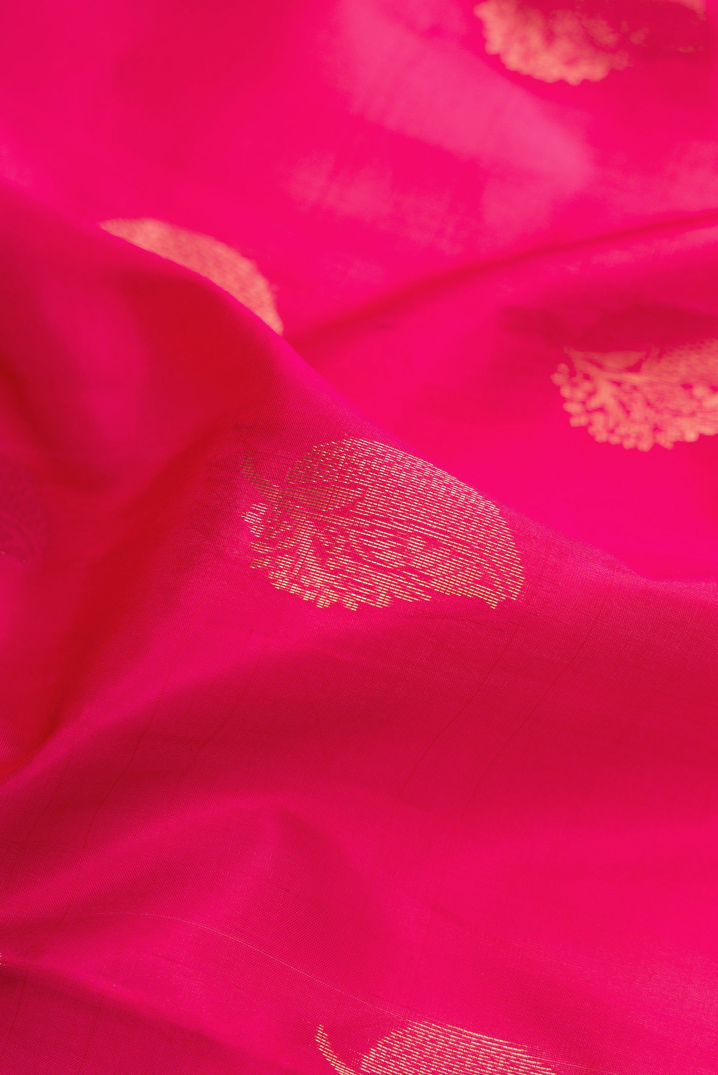 Close up of Dark Pink Soft Silk Saree with Zari Butta on the body and Fancy Border.  displaying folds