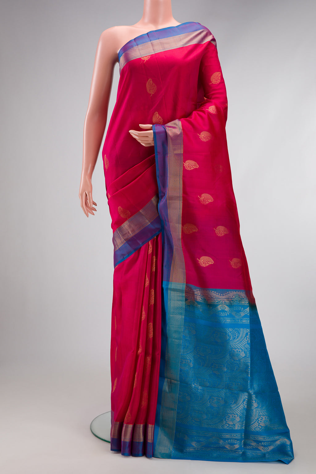 Dark Pink Soft Silk Saree with Zari Butta on the body and Fancy Border.  displayed on a mannequin