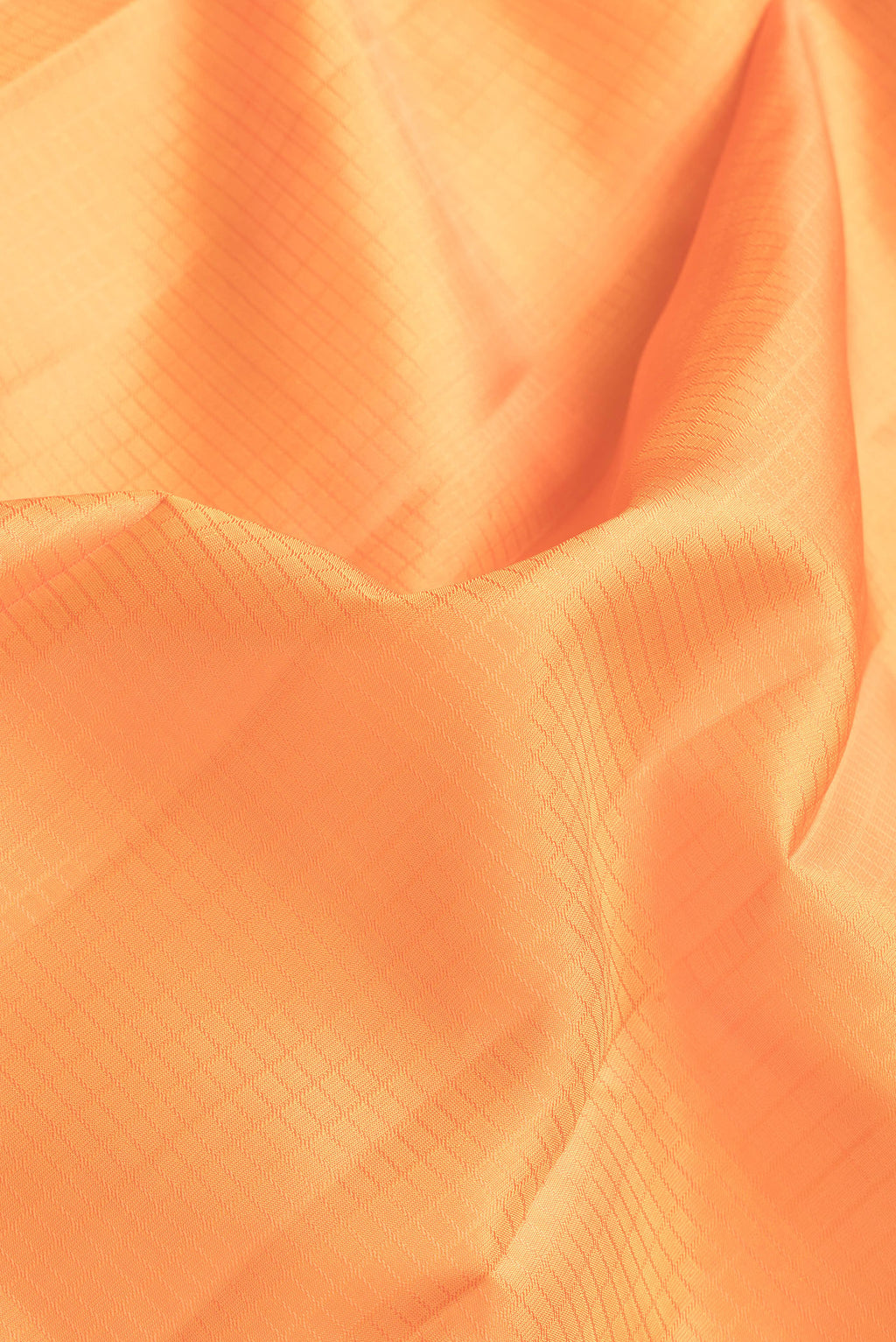 Close up of Orange Dual Tone Kanchipuram Silk Saree with Checked design on the body and Zari Border.  displaying folds