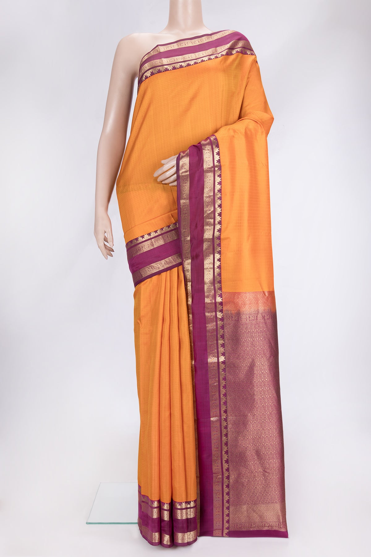 Orange Dual Tone Kanchipuram Silk Saree with Checked design on the body and Zari Border.  displayed on a mannequin