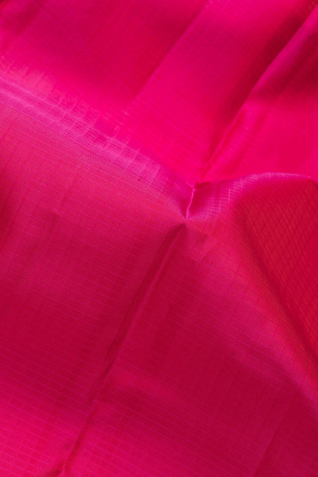 Close up of Pink Dual Tone Kanchipuram Silk Saree with Checked design on the body and Zari Border.  displaying folds