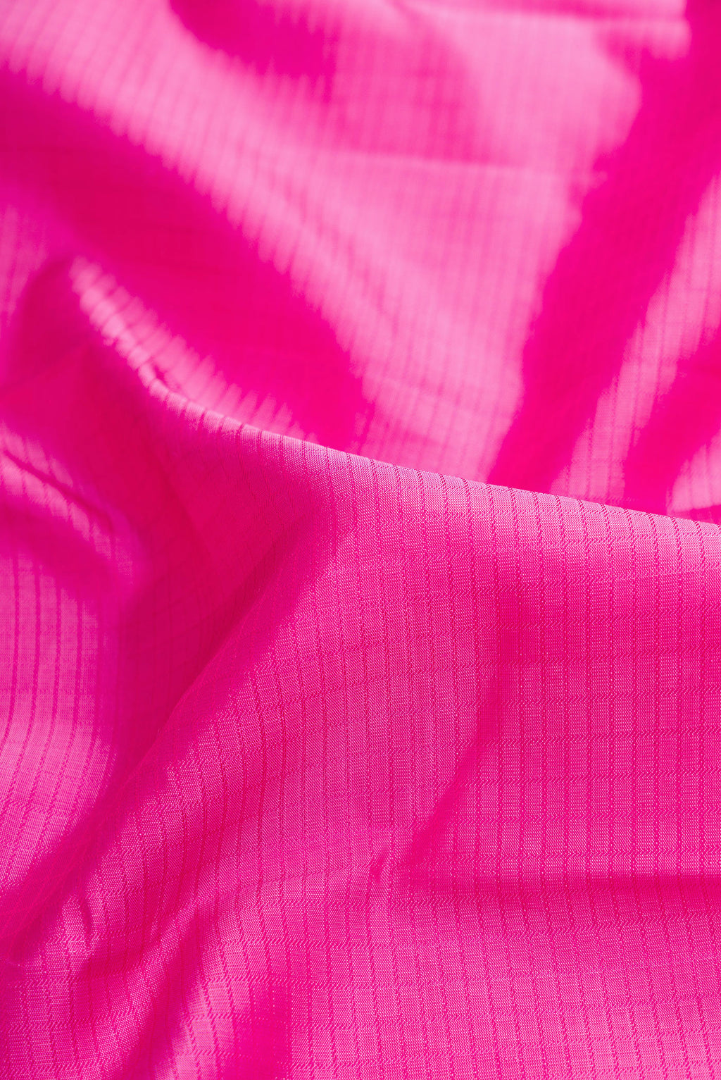 Close up of Pink Dual Tone Kanchipuram Silk Saree with Zari Butta on the body and Zari Border.  displaying folds