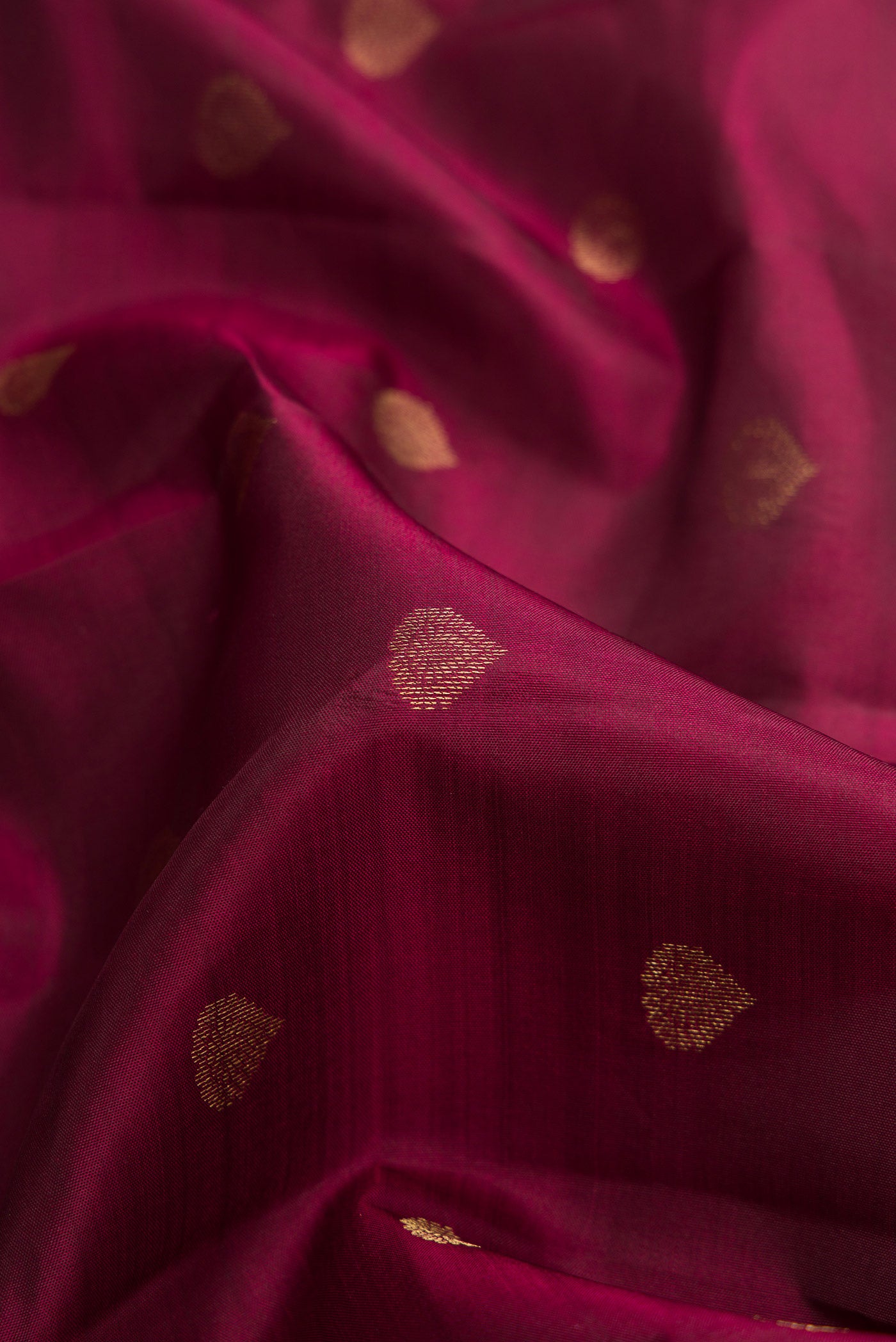 Close up of Coffee Brown Dual Tone Kanchipuram Silk Saree with Zari Butta on the body and Zari Border.  displaying folds