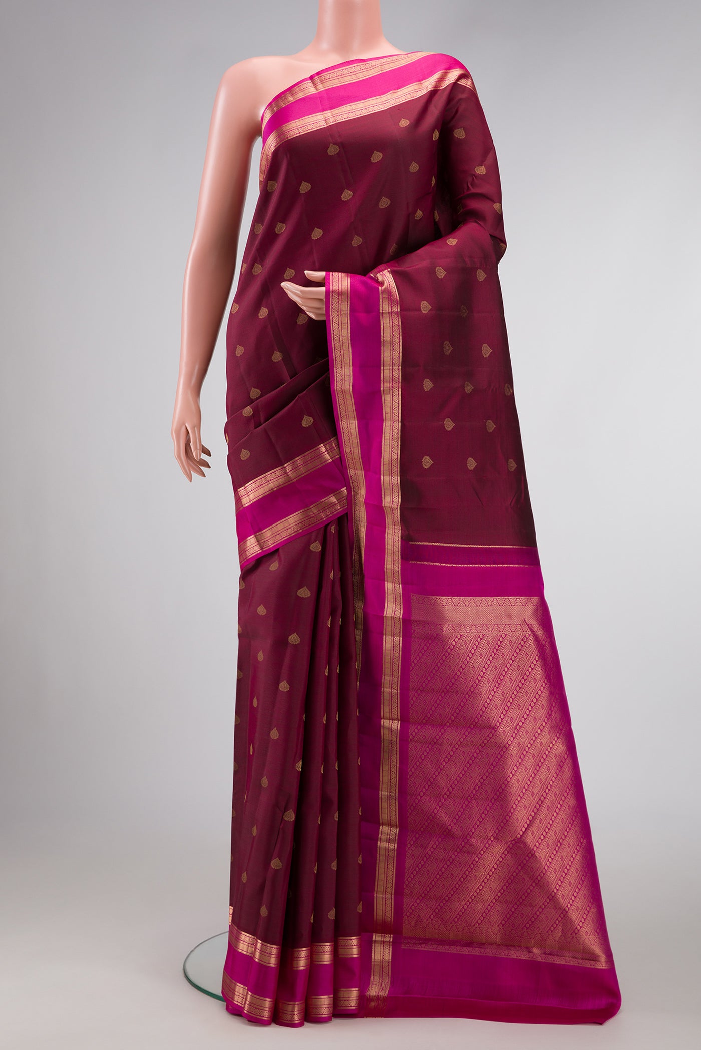Coffee Brown Dual Tone Kanchipuram Silk Saree with Zari Butta on the body and Zari Border.  displayed on a mannequin