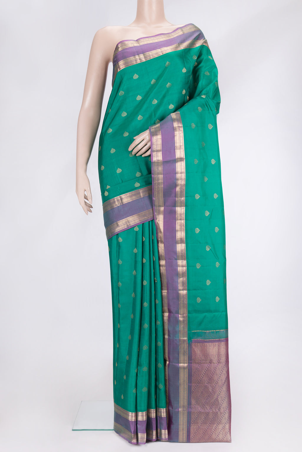 Green Dual Tone Kanchipuram Silk Saree with Zari Butta on the body and Zari Border.  displayed on a mannequin