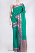 Green Dual Tone Kanchipuram Silk Saree with Zari Butta on the body and Zari Border.  displayed on a mannequin