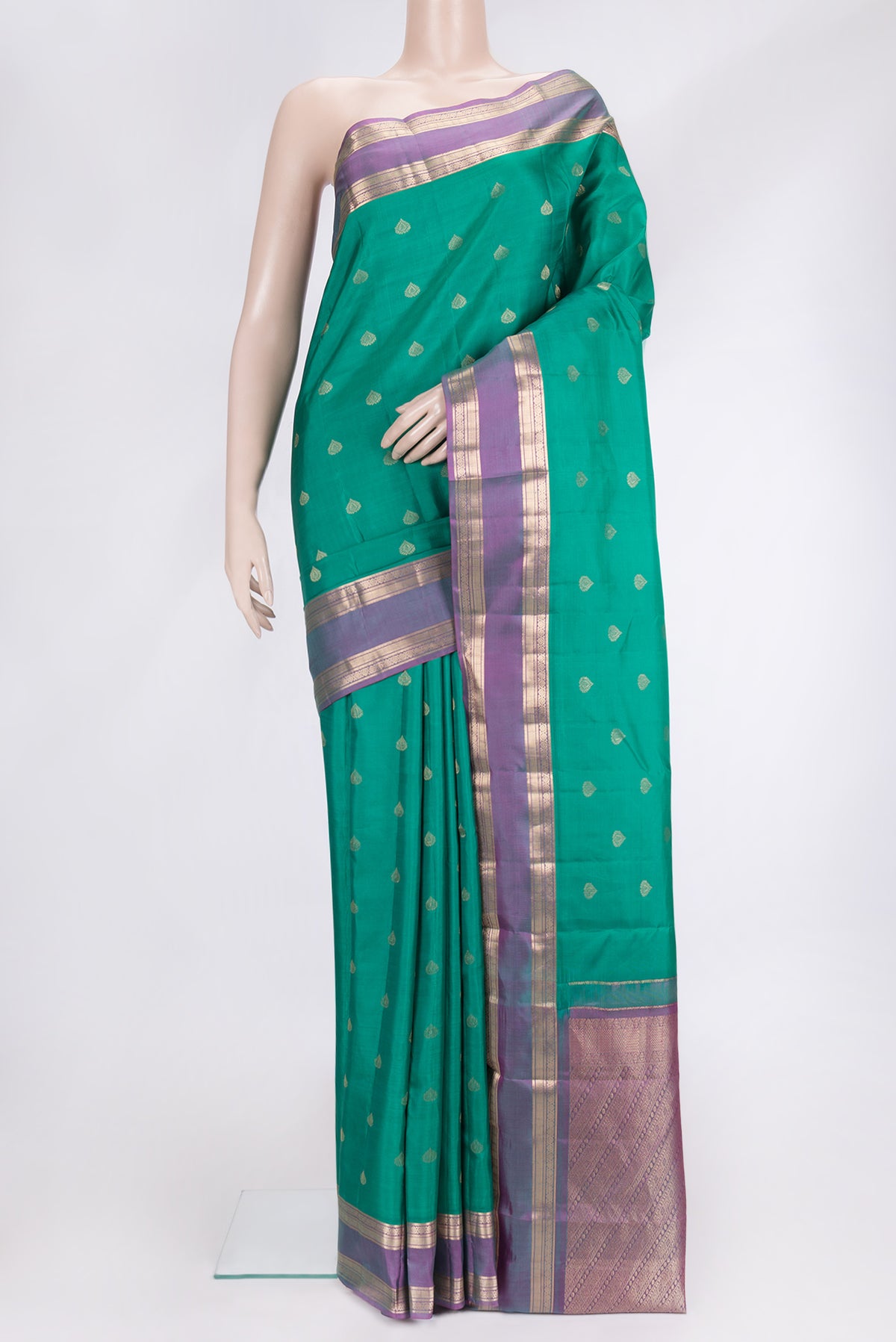 Green Dual Tone Kanchipuram Silk Saree with Zari Butta on the body and Zari Border.  displayed on a mannequin