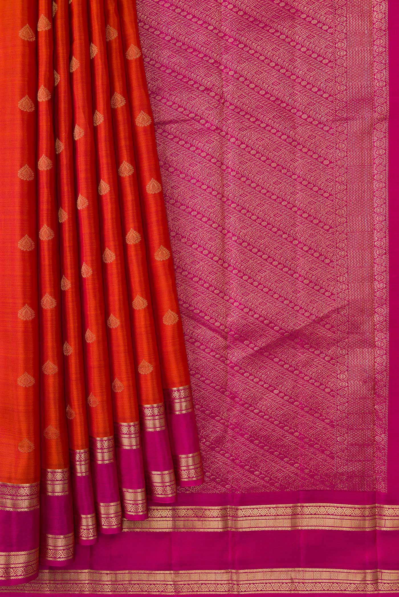 Pleats and pallu of Brick Orange Dual Tone Kanchipuram Silk Saree with Zari Butta on the body and Zari Border. 