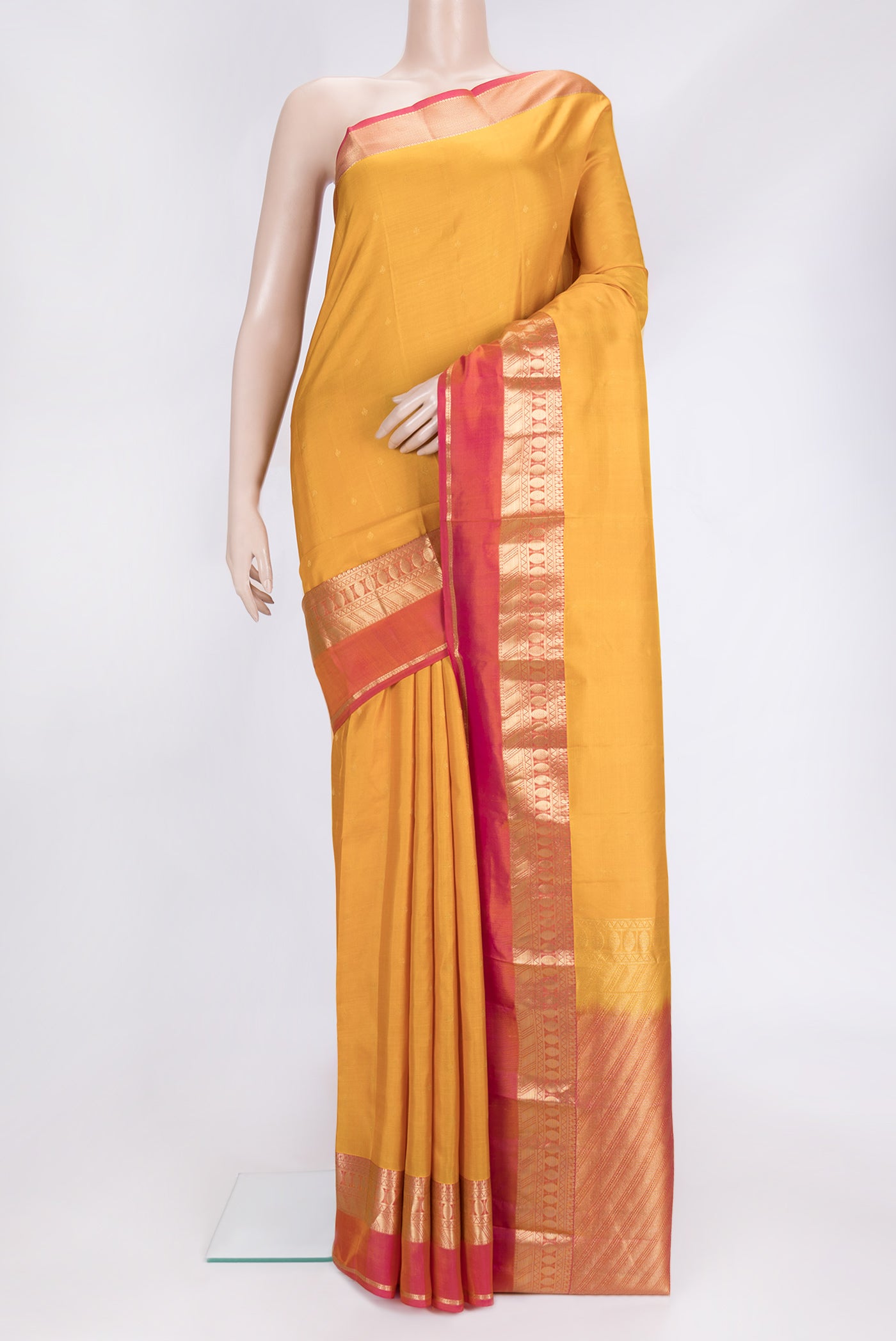 Yellow Dual Tone Kanchipuram Silk Saree with Zari Butta on the body and Zari Border.  displayed on a mannequin