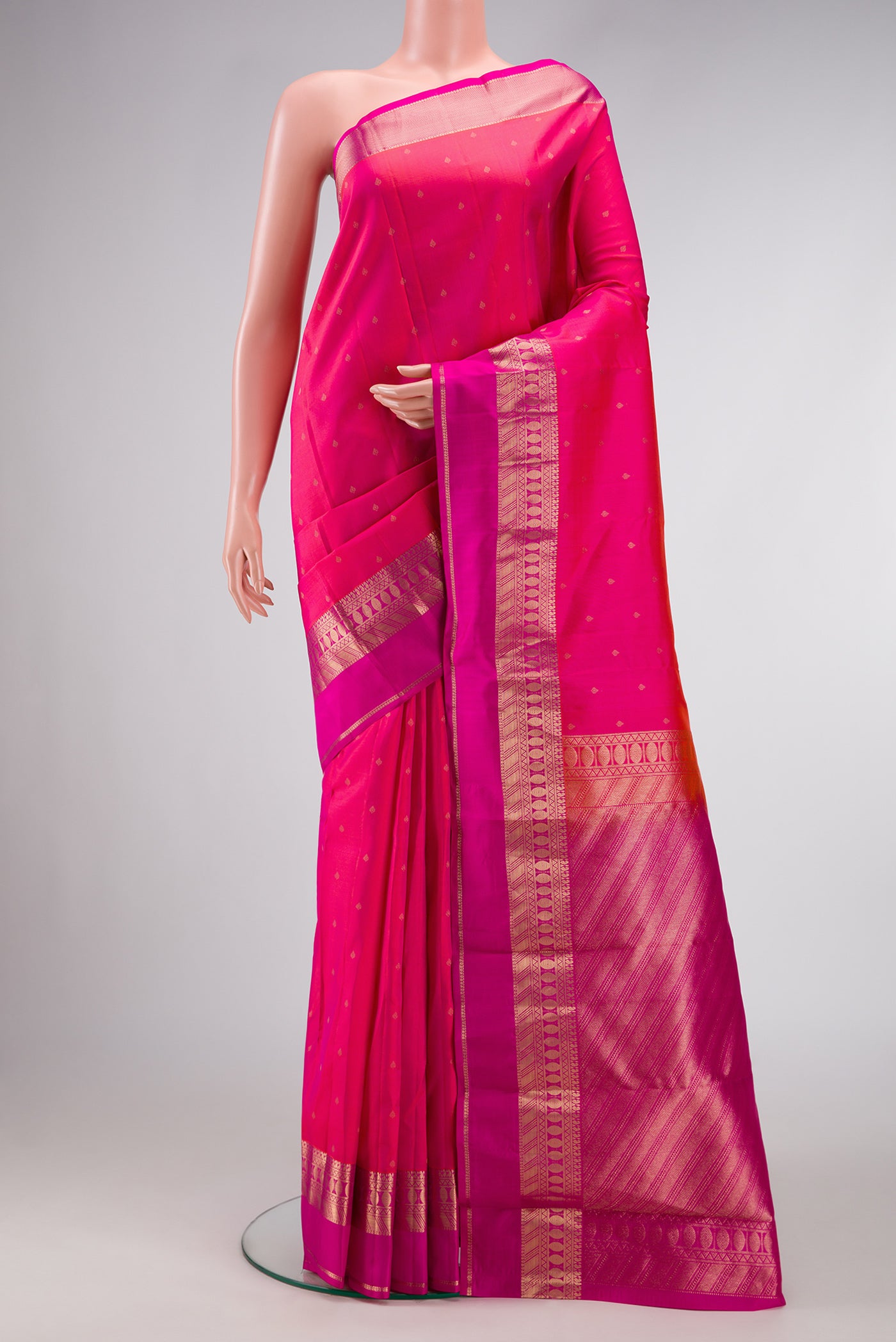 Rani Pink Dual Tone Kanchipuram Silk Saree with Zari Butta on the body and Zari Border.  displayed on a mannequin