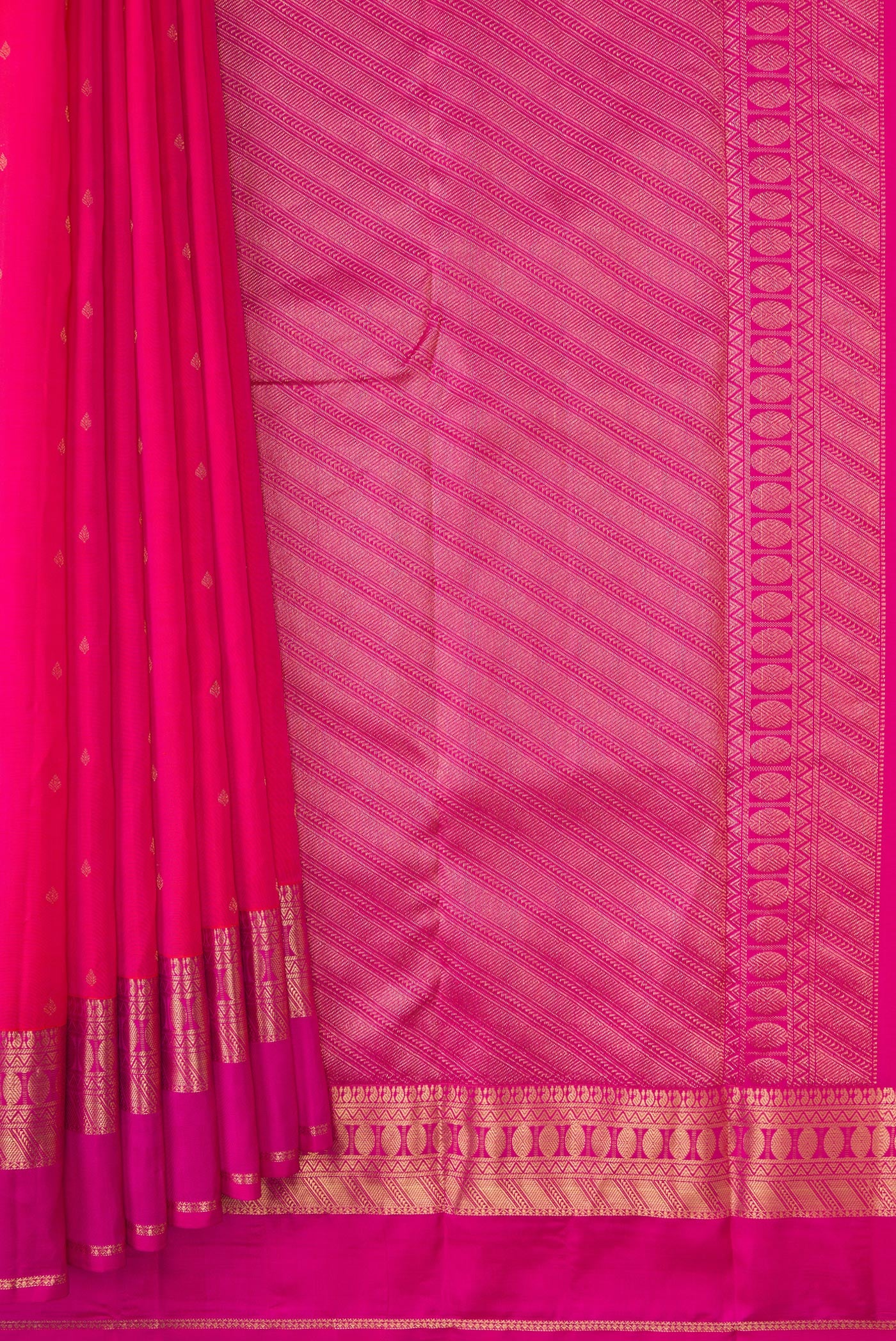 Pleats and pallu of Rani Pink Dual Tone Kanchipuram Silk Saree with Zari Butta on the body and Zari Border. 