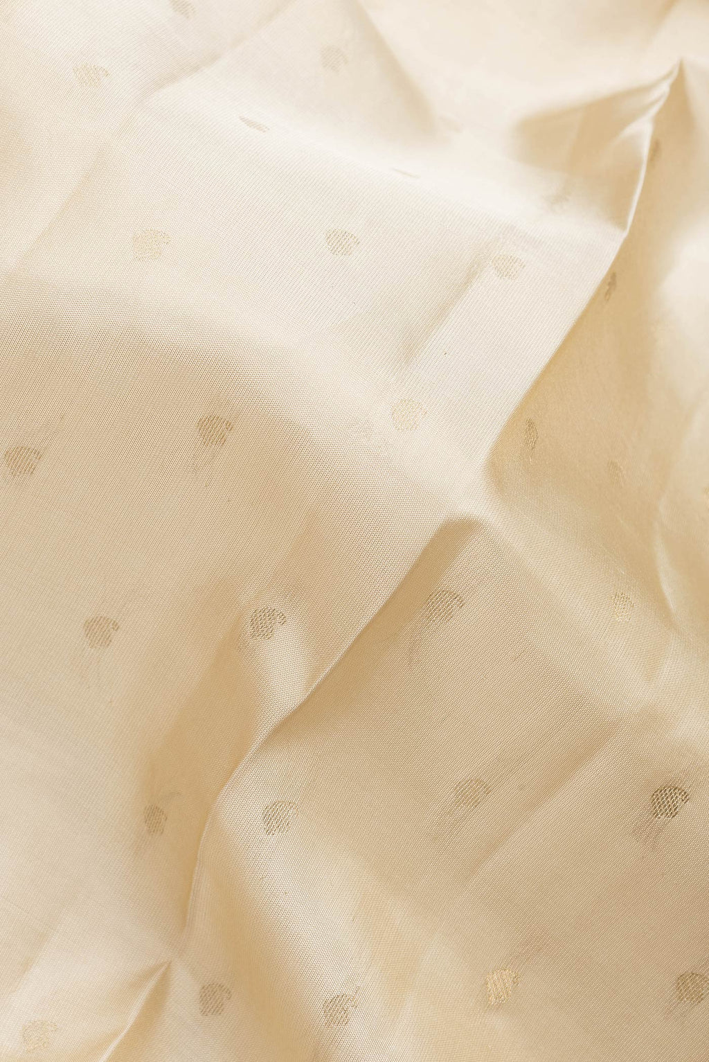 Close up of Beige Dual Tone Kanchipuram Silk Saree with Zari Butta on the body and Zari Border.  displaying folds