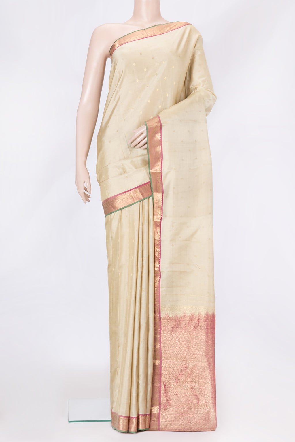 Beige Dual Tone Kanchipuram Silk Saree with Zari Butta on the body and Zari Border.  displayed on a mannequin