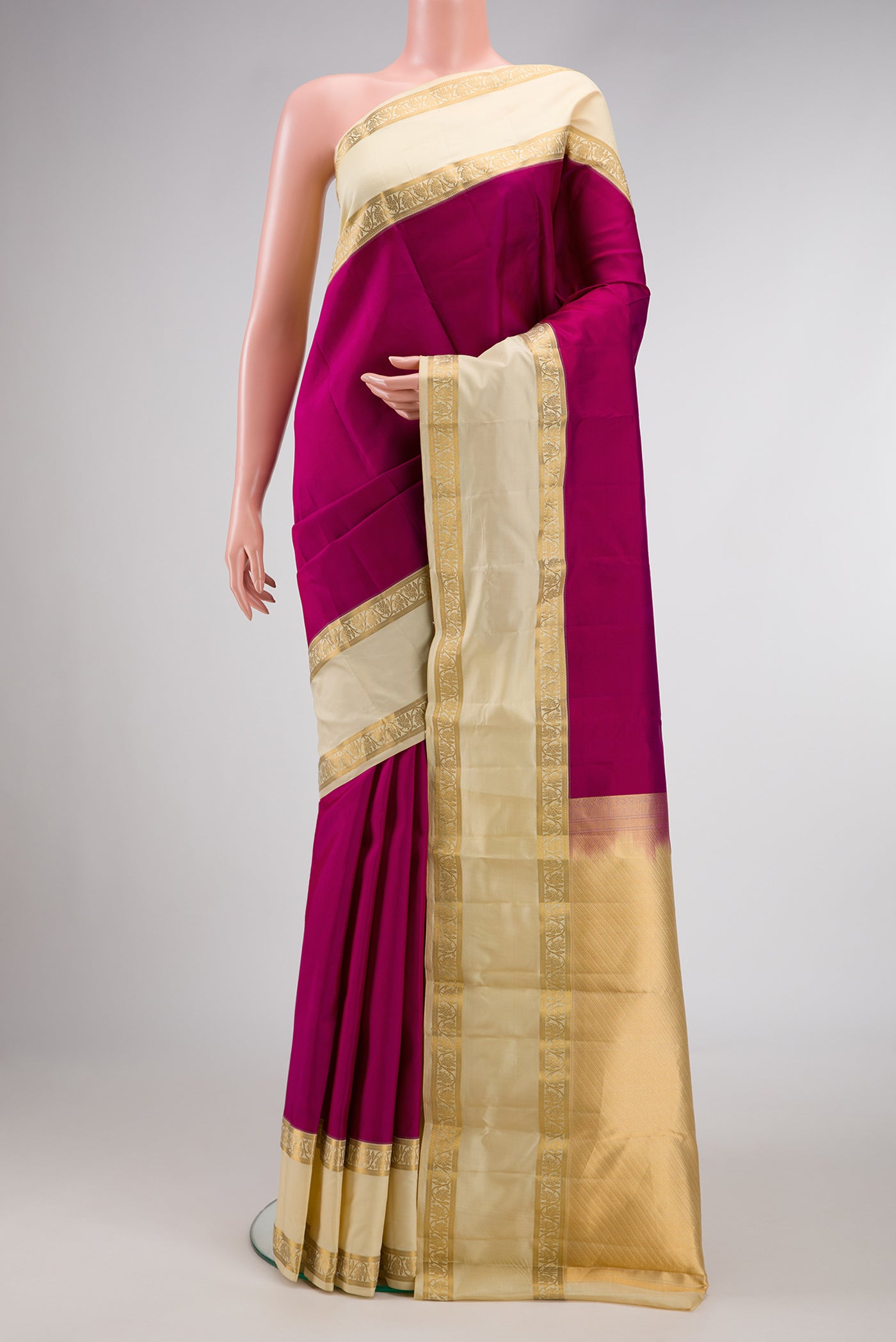 Magenta Dual Tone Kanchipuram Silk Saree with Plain Body and Thin Zari Line.  displayed on a mannequin