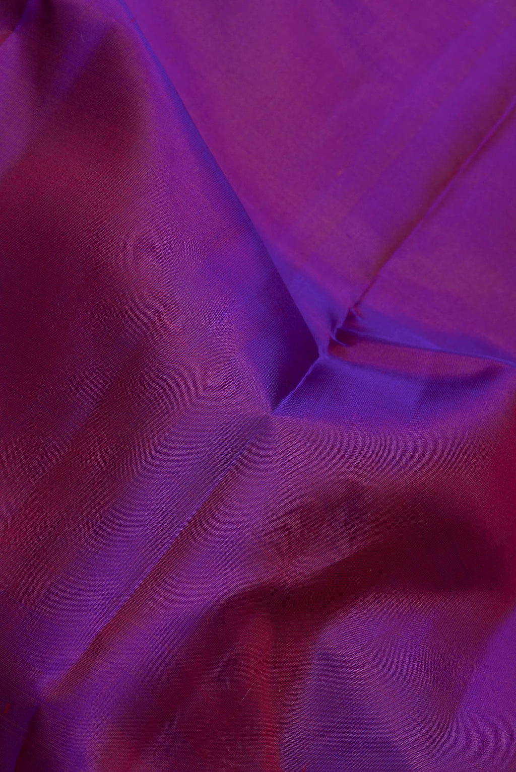 Close up of Purple Dual Tone Kanchipuram Silk Saree with Zari Butta on the body and Zari Border.  displaying folds