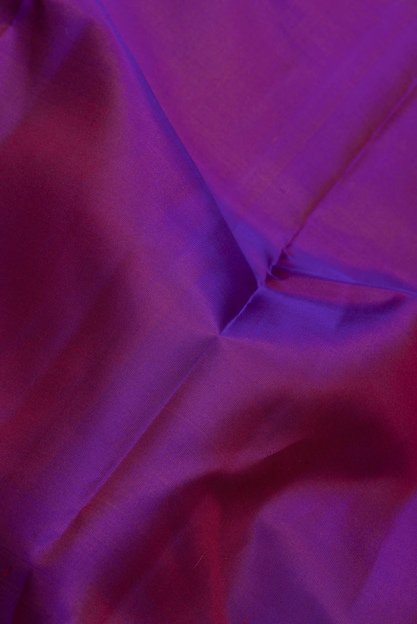 Close up of Purple Dual Tone Kanchipuram Silk Saree with Zari Butta on the body and Zari Border.  displaying folds