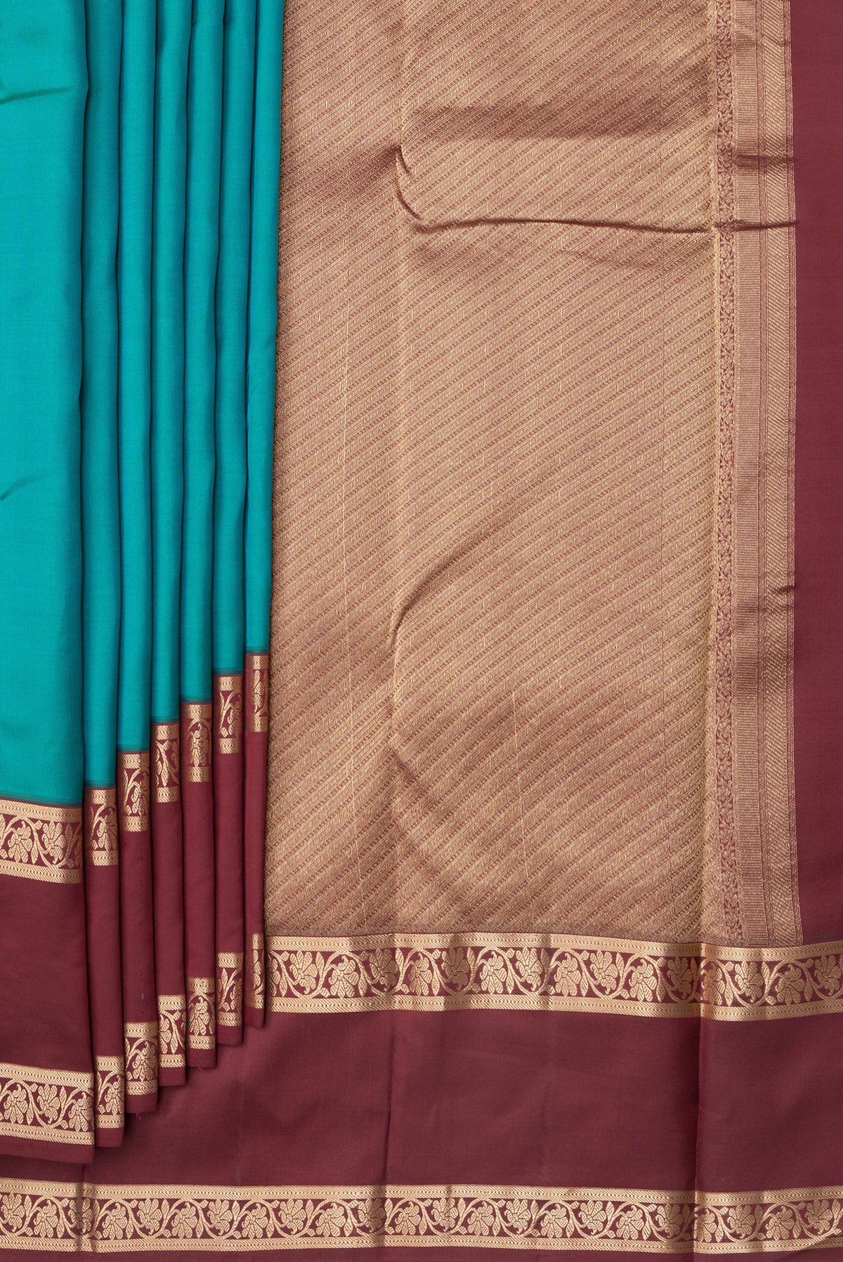 Pleats and pallu of Peacock Blue Kanchipuram Silk Saree with Plain Body and Zari Border. 
