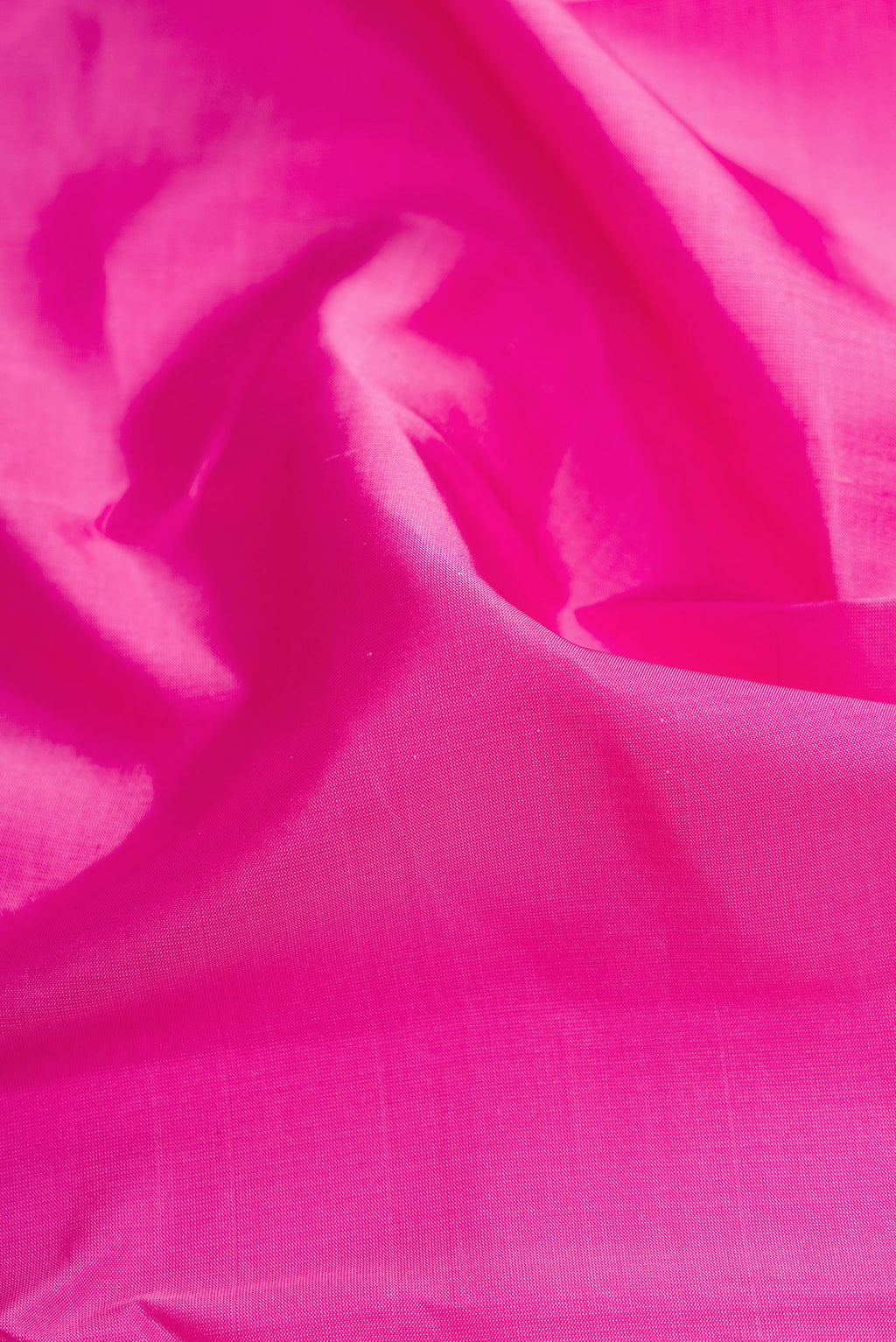 Close up of Pink Dual Tone Kanchipuram Silk Saree with Plain Body and Zari Border.  displaying folds