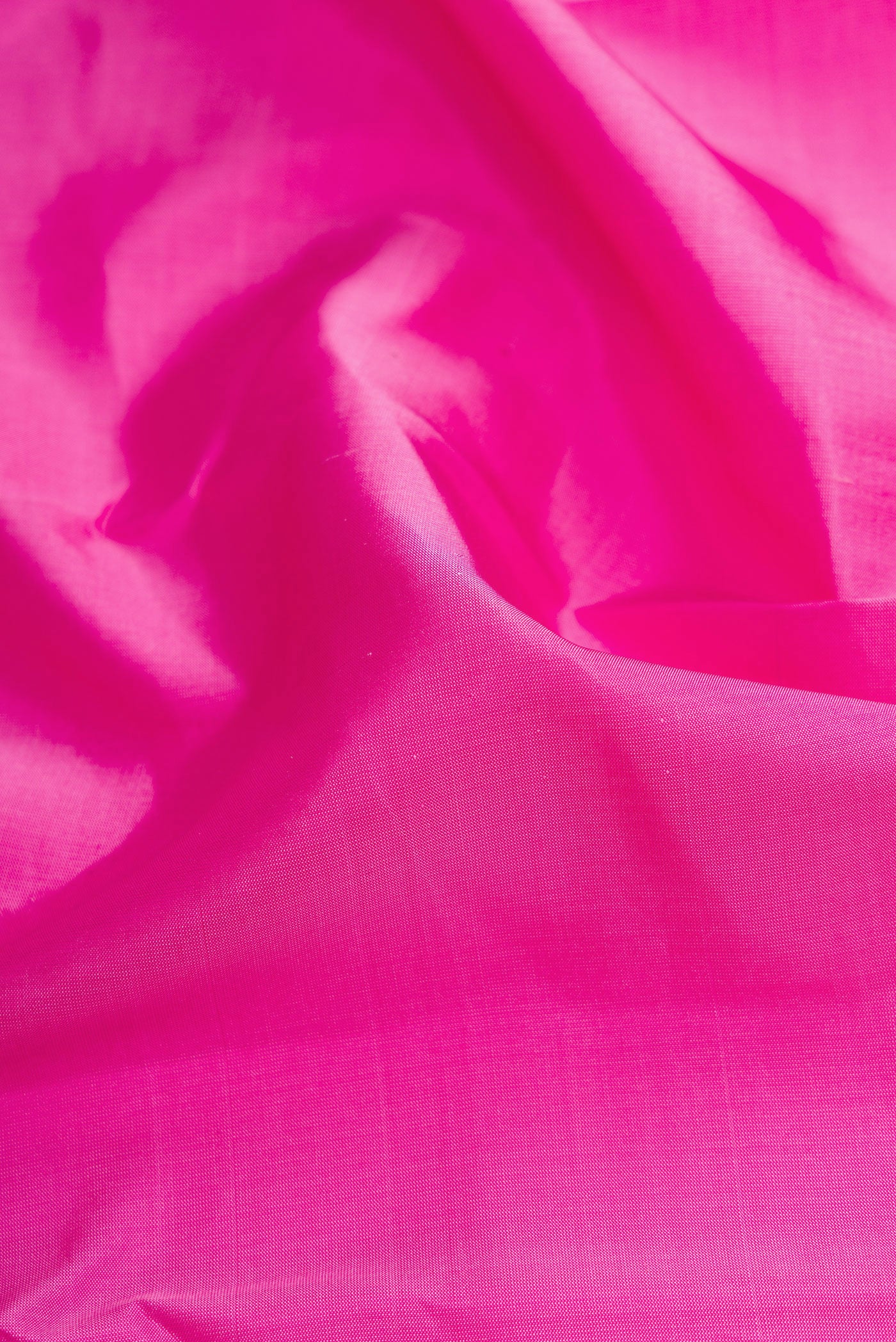 Close up of Pink Dual Tone Kanchipuram Silk Saree with Plain Body and Zari Border.  displaying folds