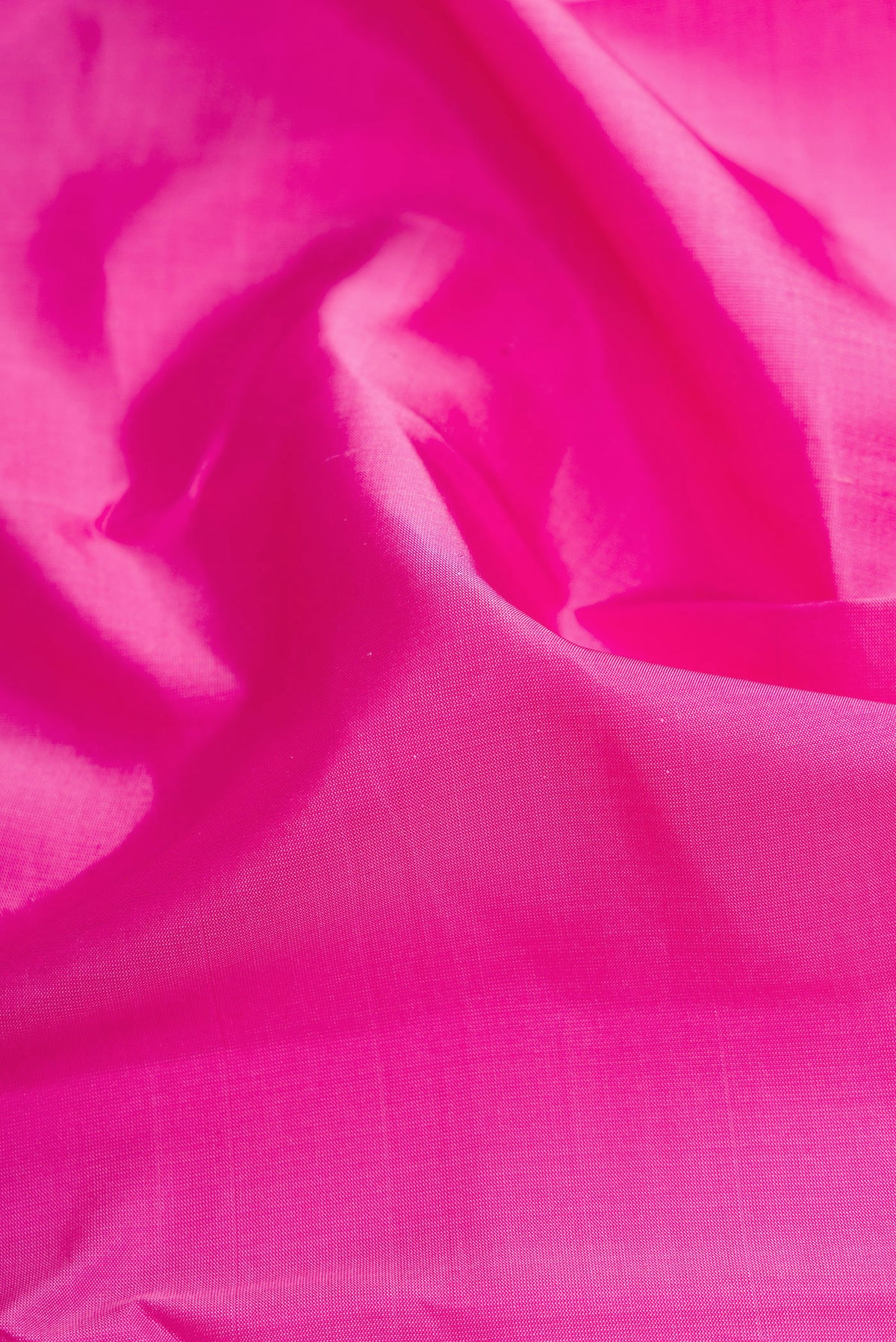 Close up of Pink Dual Tone Kanchipuram Silk Saree with Plain Body and Zari Border.  displaying folds