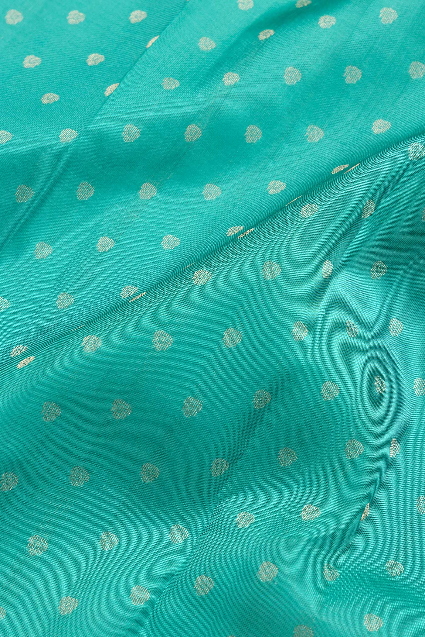 Close up of Sea Green Dual Tone Kanchipuram Silk Saree with Zari Butta on the body and Zari Border.  displaying folds