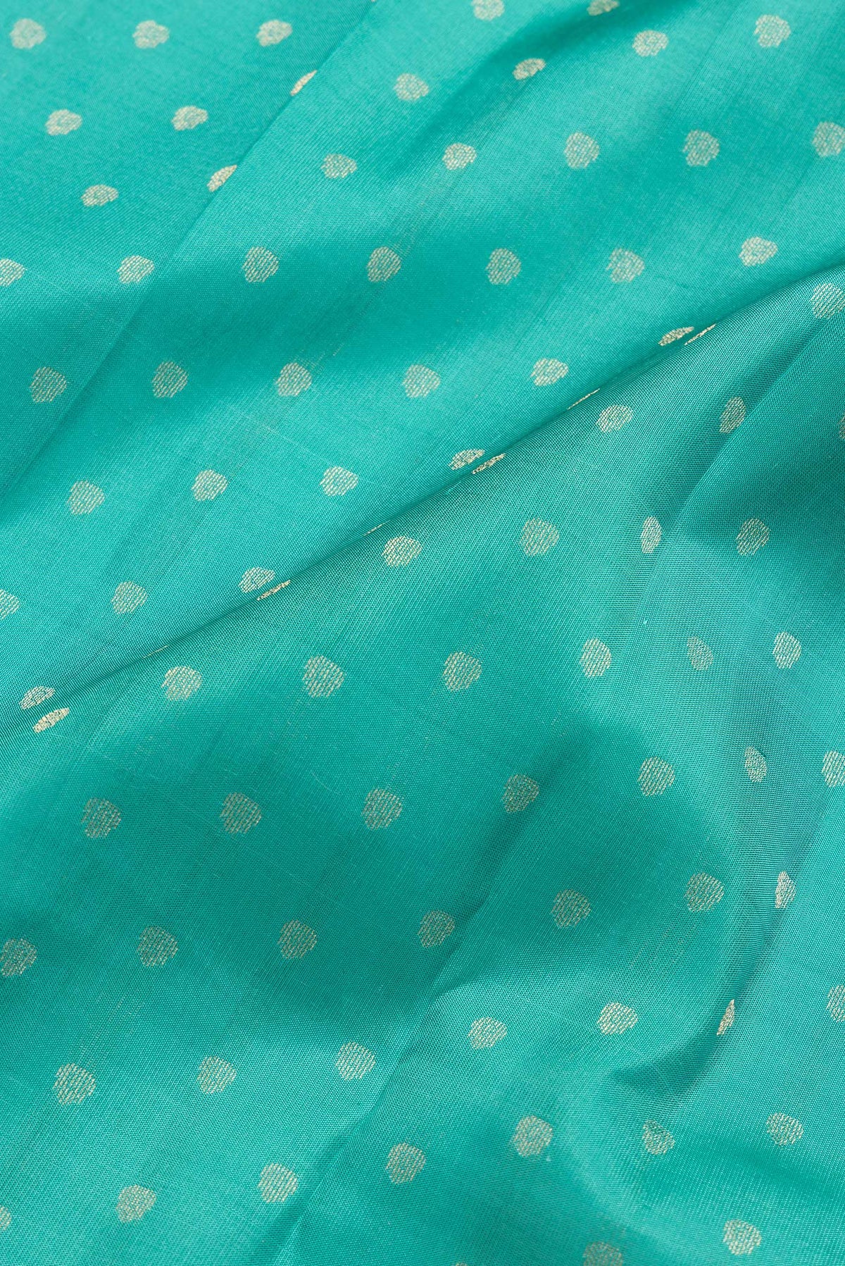Close up of Sea Green Dual Tone Kanchipuram Silk Saree with Zari Butta on the body and Zari Border.  displaying folds