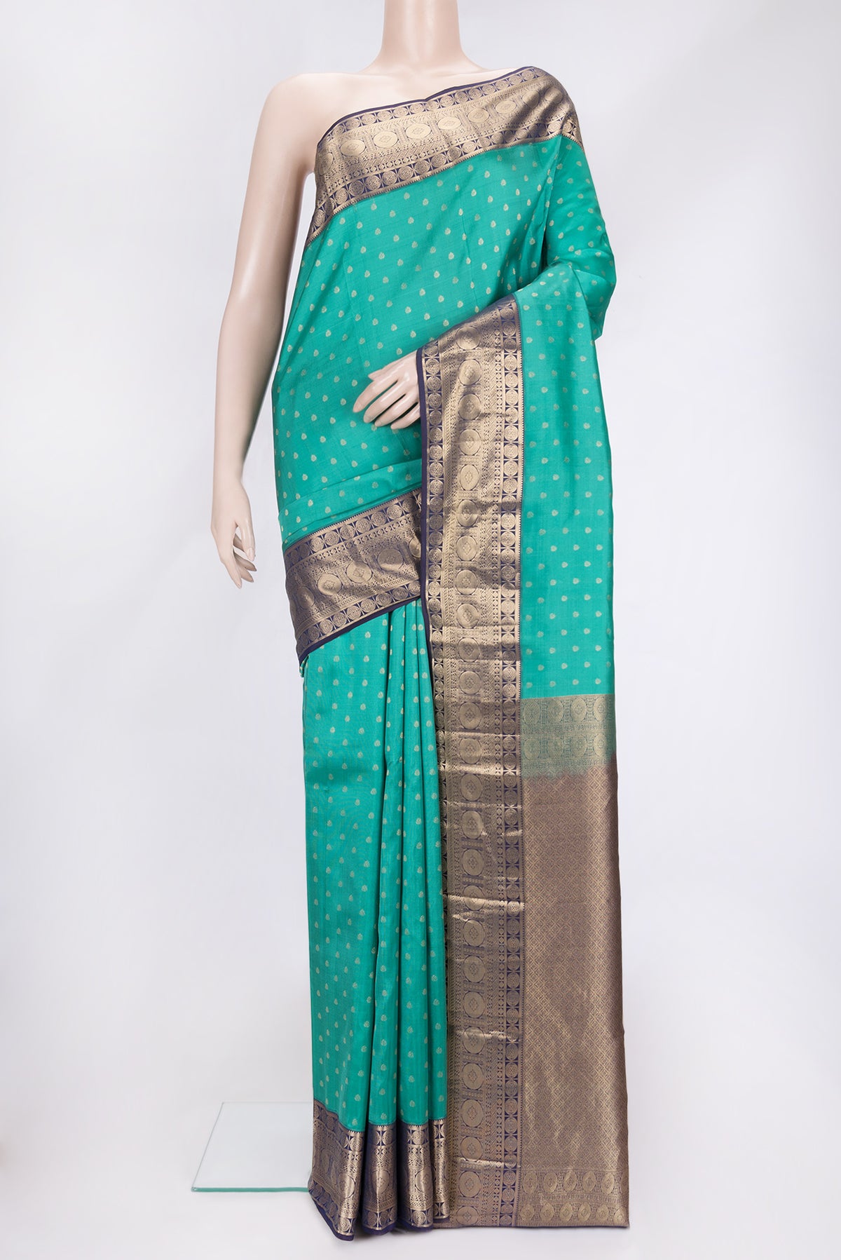 Sea Green Dual Tone Kanchipuram Silk Saree with Zari Butta on the body and Zari Border.  displayed on a mannequin