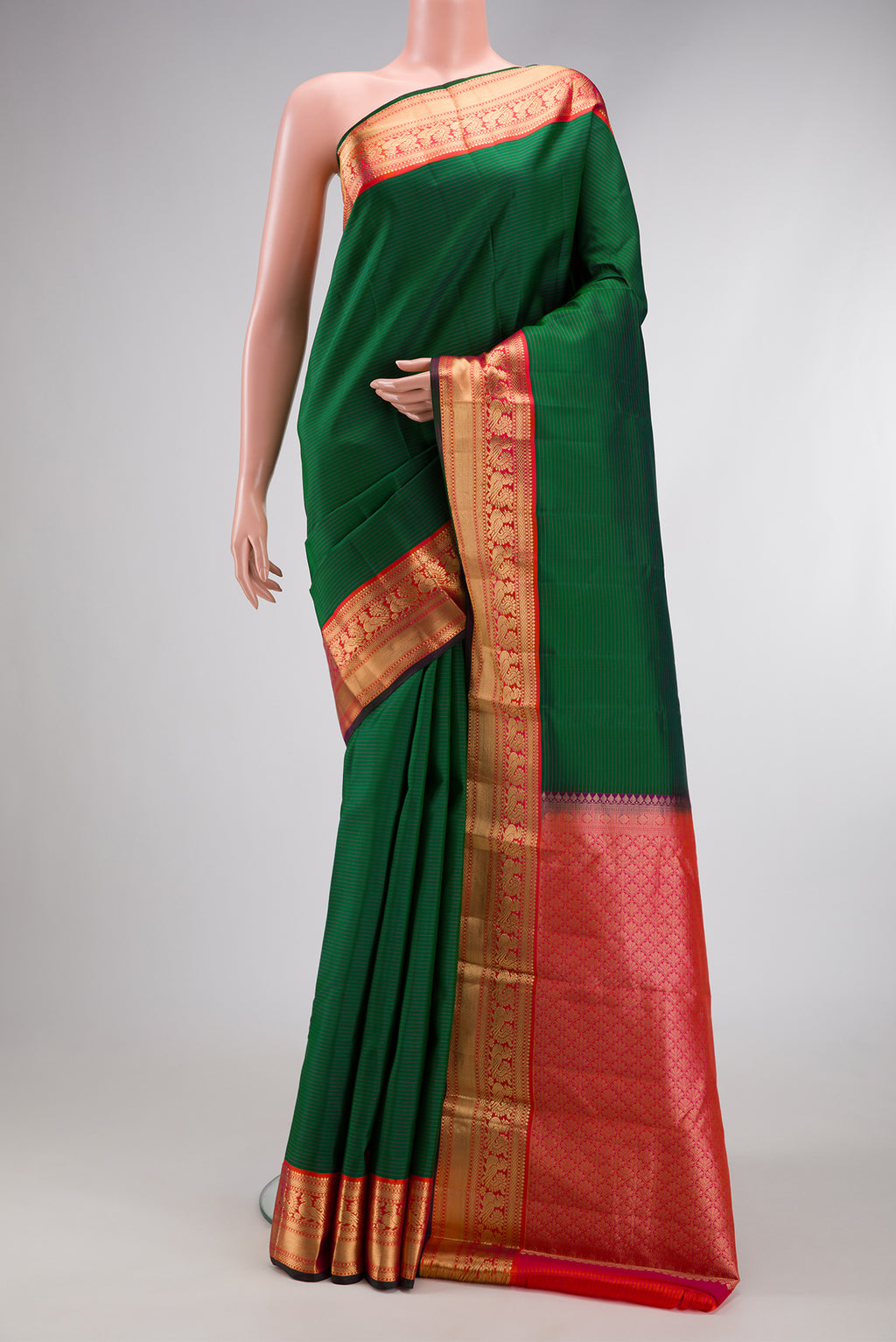 Bottle Green Dual Tone Kanchipuram Silk Saree with Stripes on the body and Zari Border.  displayed on a mannequin