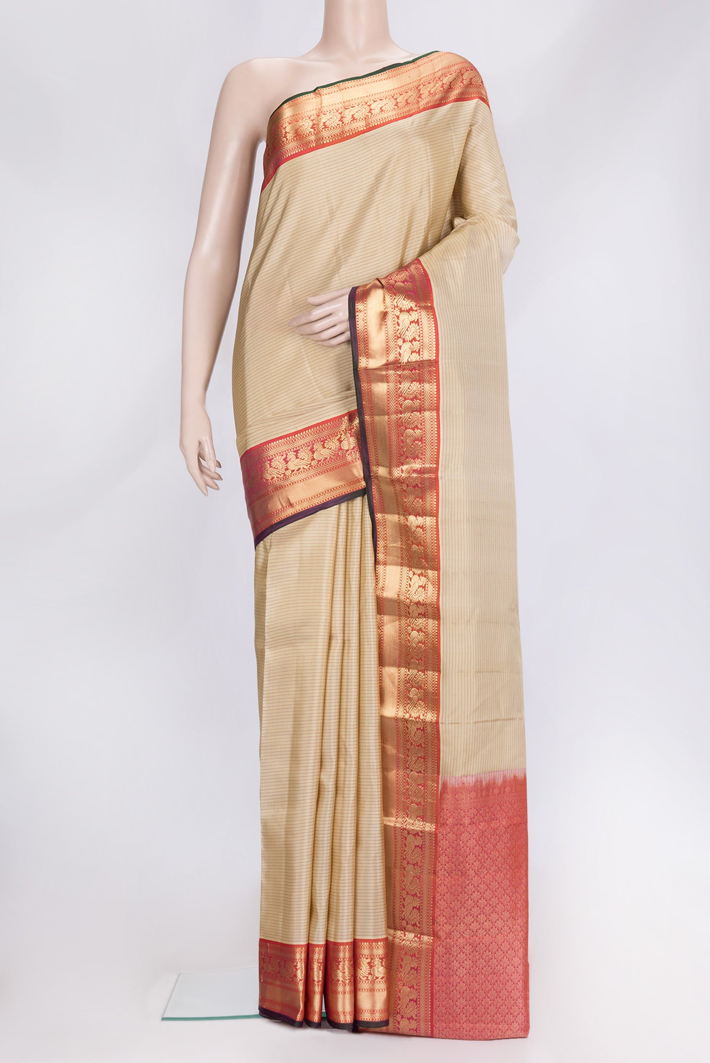 Beige Dual Tone Kanchipuram Silk Saree with Stripes on the body and Zari Border.  displayed on a mannequin