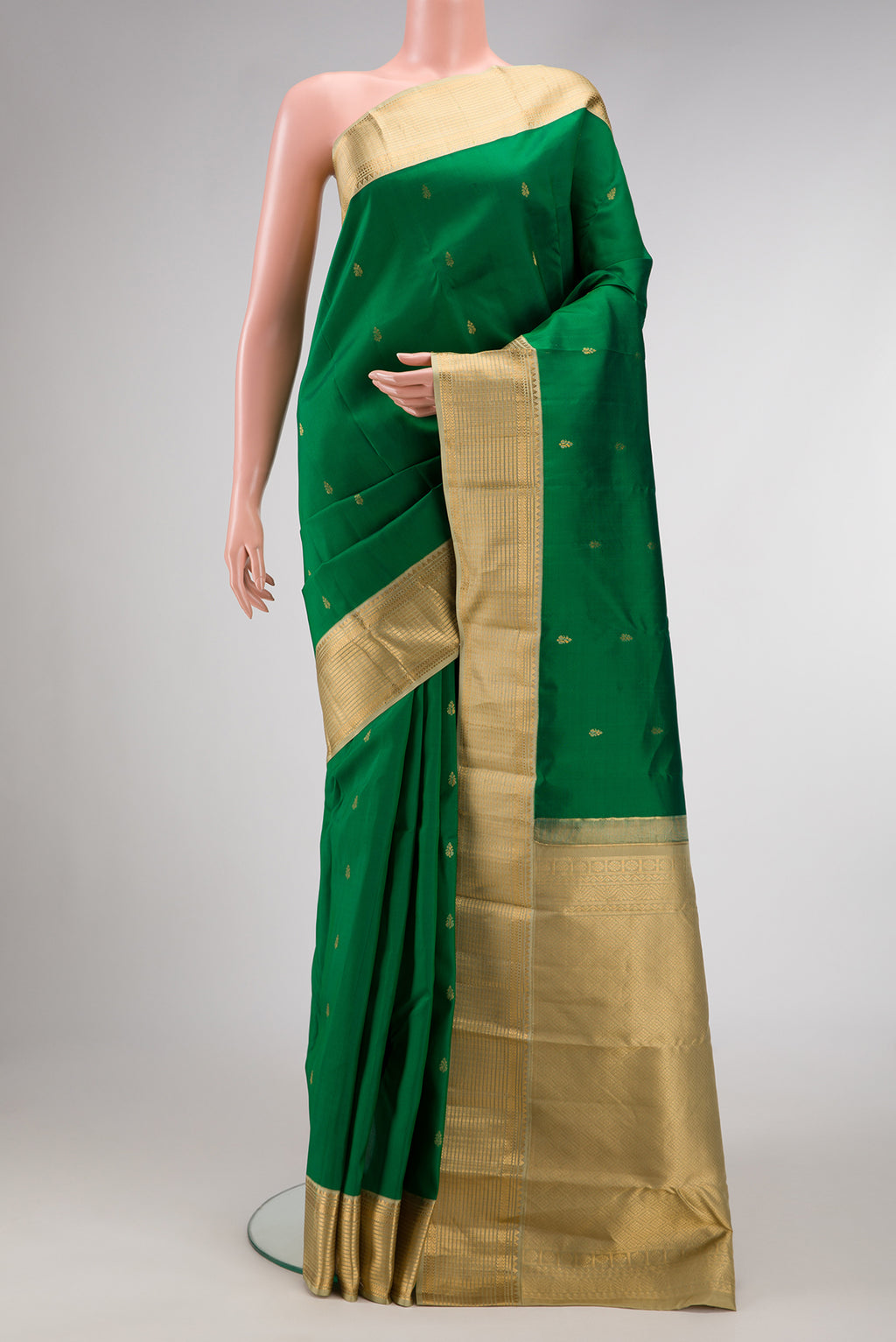 Green Dual Tone Kanchipuram Silk Saree with Zari Butta on the body and Zari Border.  displayed on a mannequin