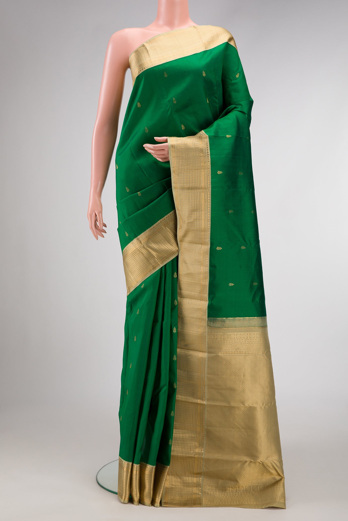 Green Dual Tone Kanchipuram Silk Saree with Zari Butta on the body and Zari Border.  displayed on a mannequin