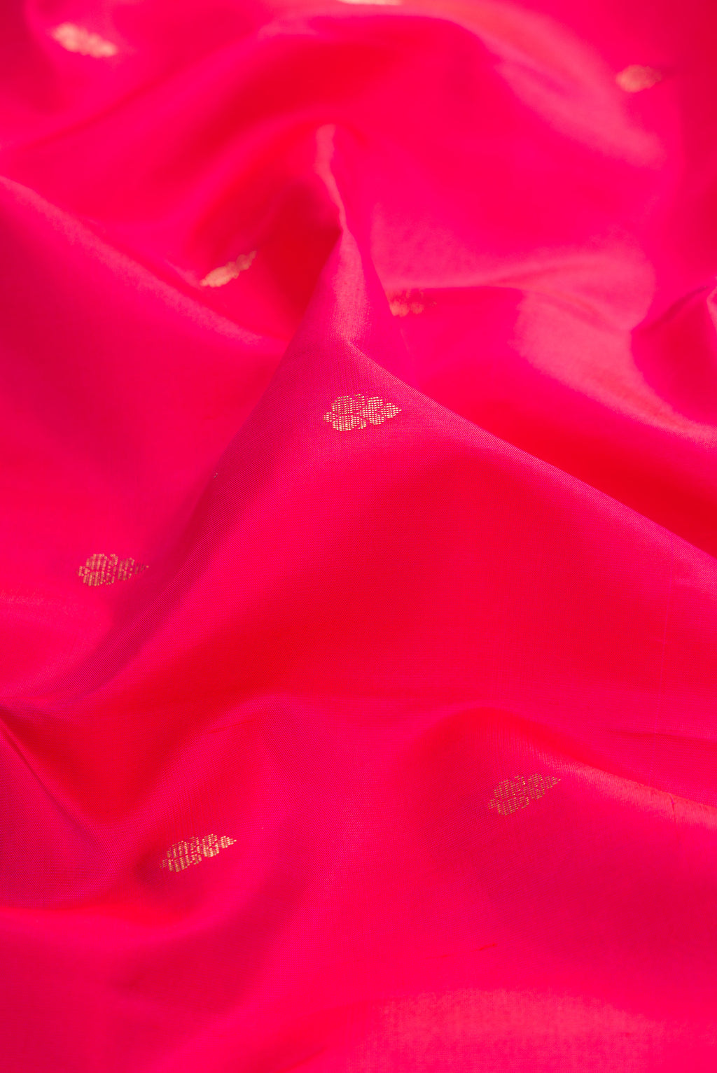 Close up of Pink Dual Tone Kanchipuram Silk Saree with Zari Butta on the body and Zari Border.  displaying folds