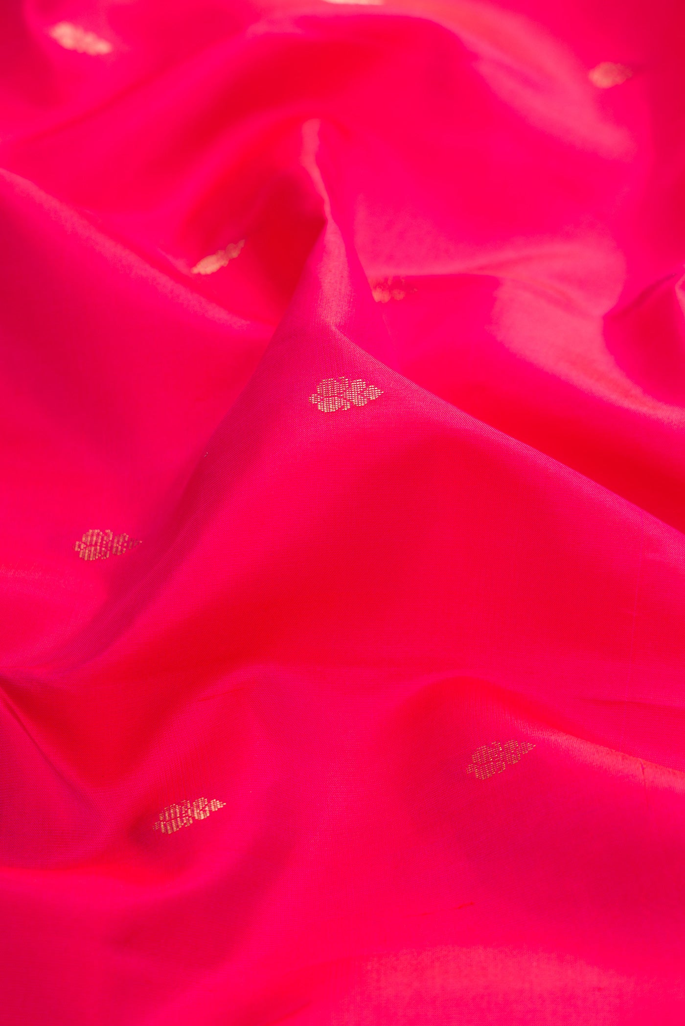 Close up of Pink Dual Tone Kanchipuram Silk Saree with Zari Butta on the body and Zari Border.  displaying folds