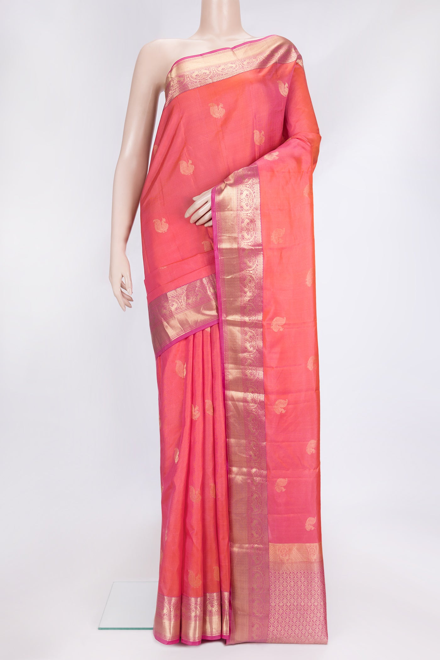 Coral Dual Tone Kanchipuram Silk Saree with Zari Butta on the body and Zari Border.  displayed on a mannequin
