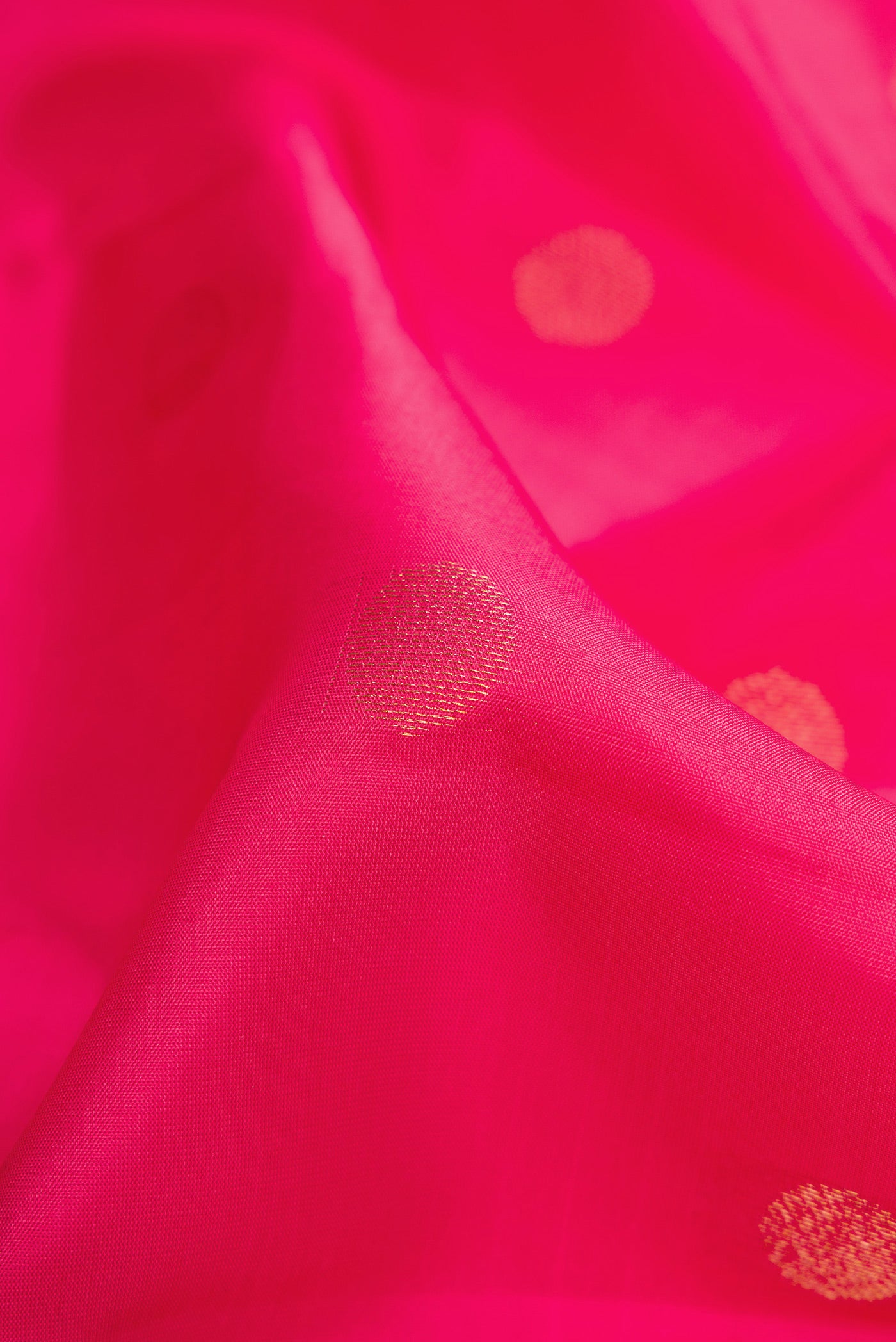 Close up of Pink Dual Tone Kanchipuram Silk Saree with Zari Butta on the body and Zari Border.  displaying folds