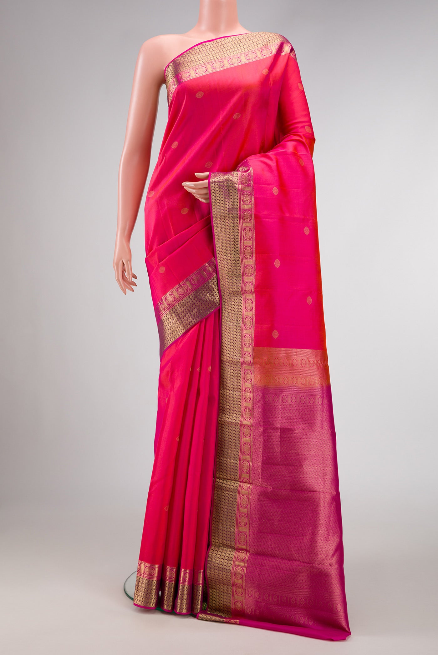 Pink Dual Tone Kanchipuram Silk Saree with Zari Butta on the body and Zari Border.  displayed on a mannequin